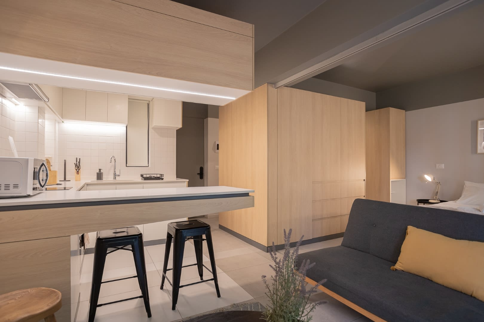 Experience modern comfort in this stylish open-plan space, featuring a sleek kitchen and cozy living area perfect for relaxation.