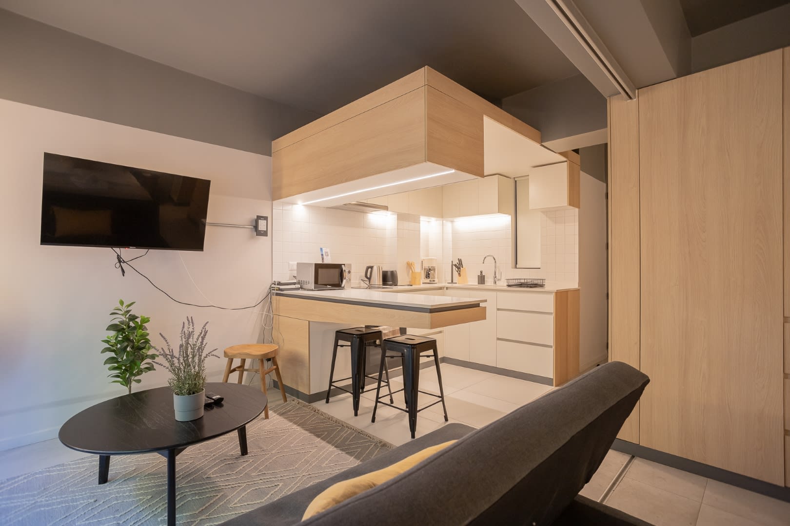 Chic and cozy open-plan kitchen and living area, perfect for relaxing or entertaining in style.