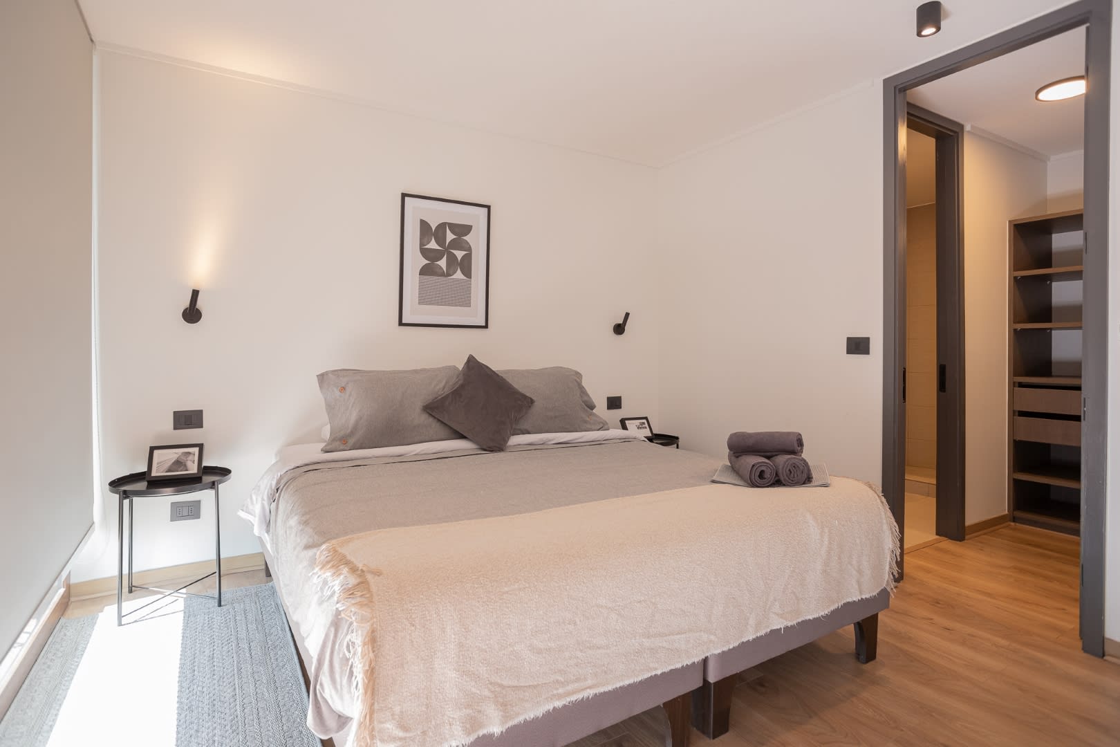 Relax in this serene bedroom with modern decor and ample storage, perfect for a peaceful getaway.