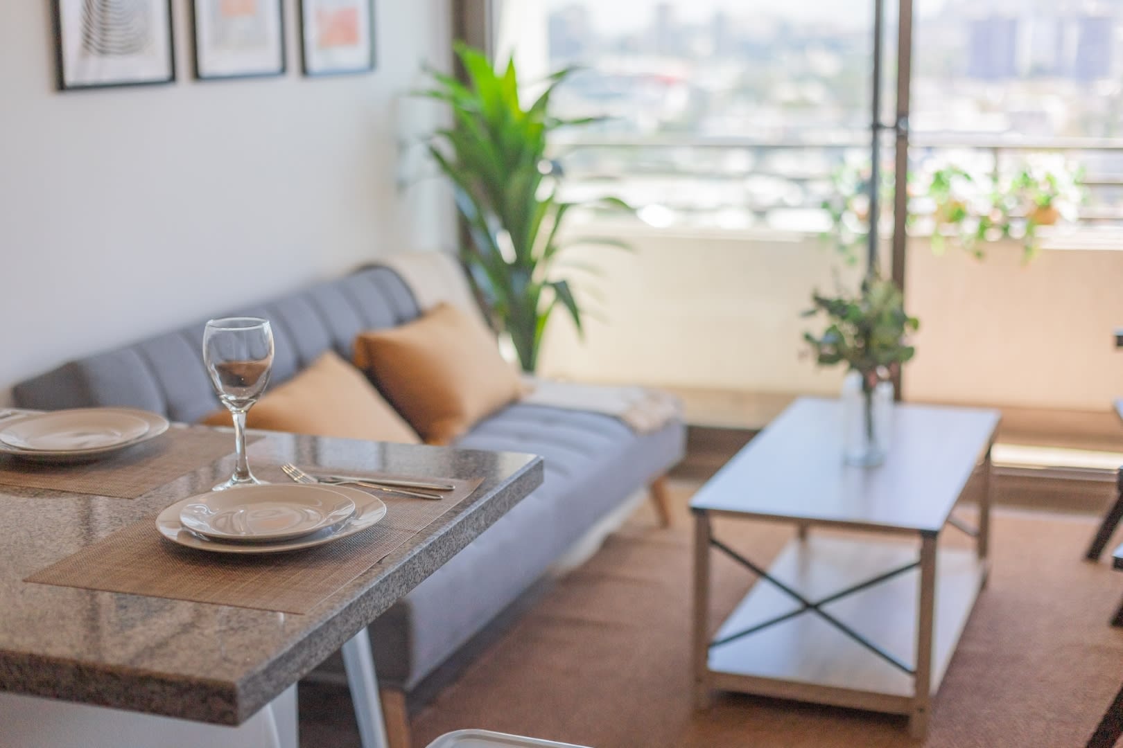 Bright and cozy living area with a stunning city view from the balcony, perfect for relaxation.