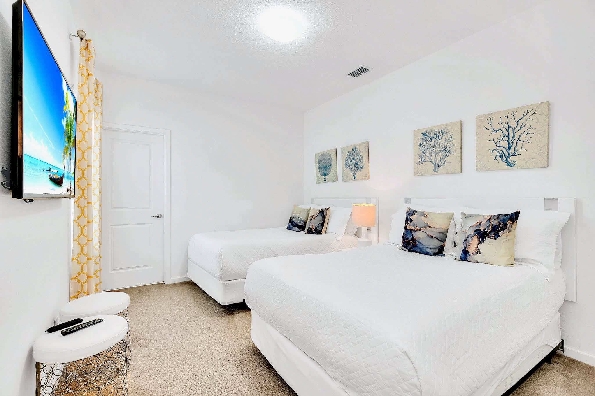 Bright And Inviting Bedroom With Plush Bedding And Smart TV