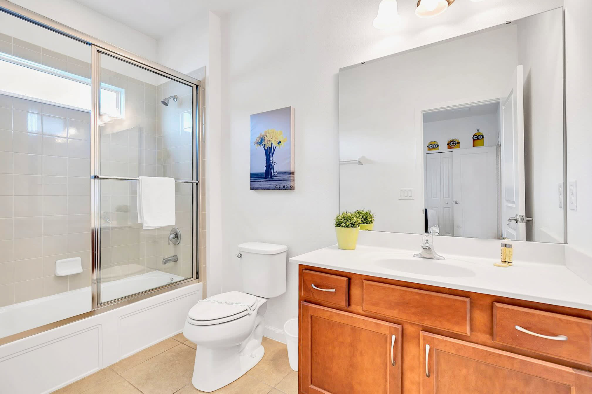 Sleek Bathroom Featuring A Spacious Shower And Large Vanity