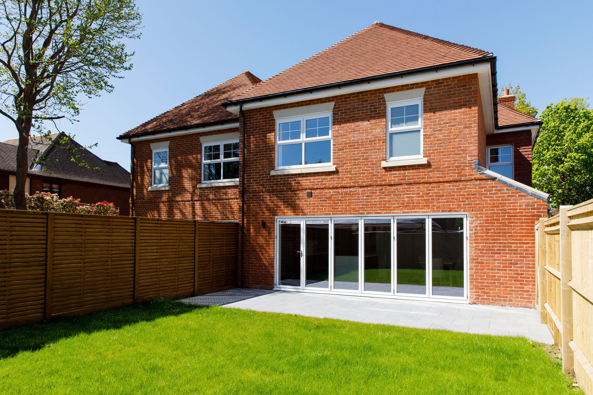 The open plan living space leads out onto a beautifully lawned garden.