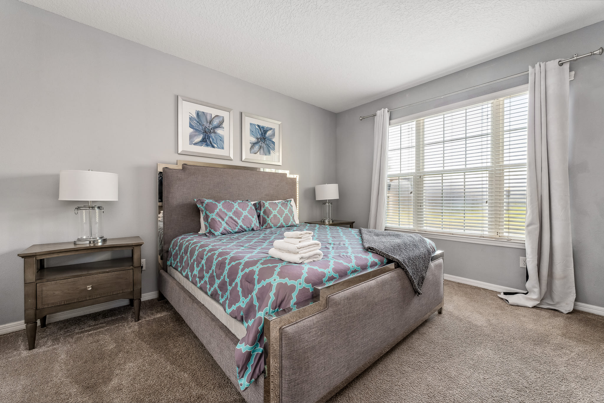 Cozy bedroom w/ soft bedding and calming decor for restful nights.