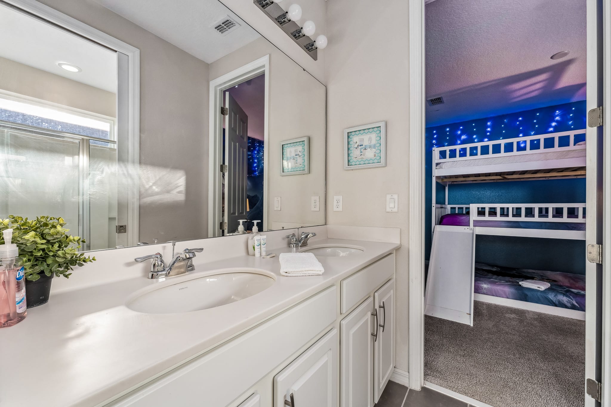 Sleek bathroom w/ double sink vanity and clean, modern finishes.