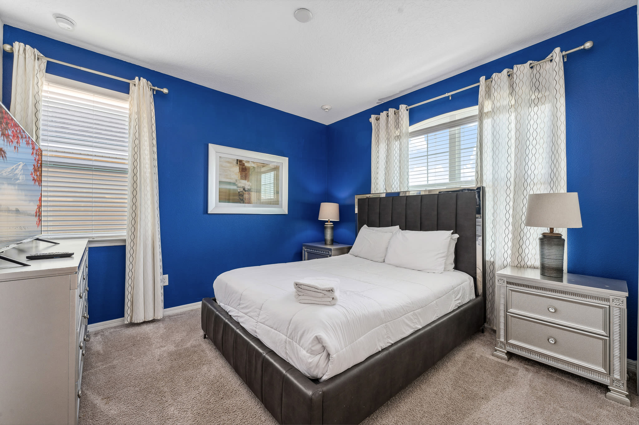 Calm bedroom w/ soft tones and simple decor for restful nights.