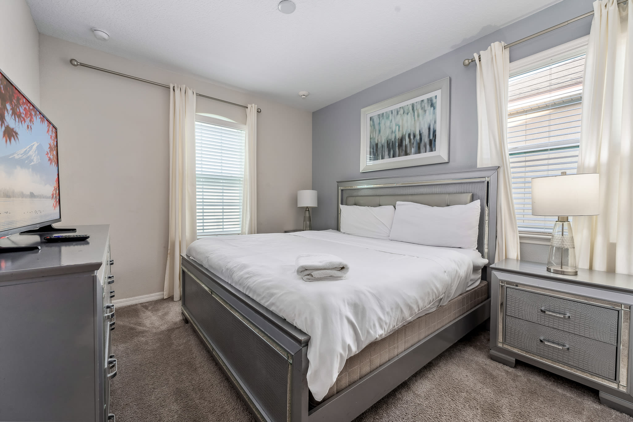 Clean bedroom w/ simple decor and a peaceful, uncluttered feel.
