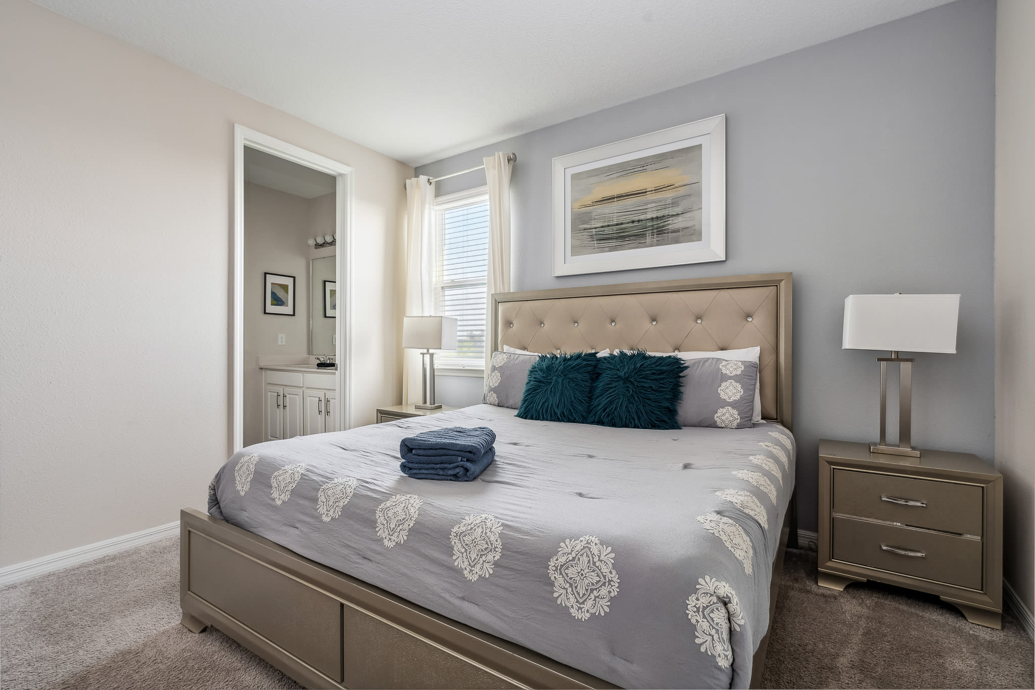 Spacious bedroom w/ plush bedding and calming decor.