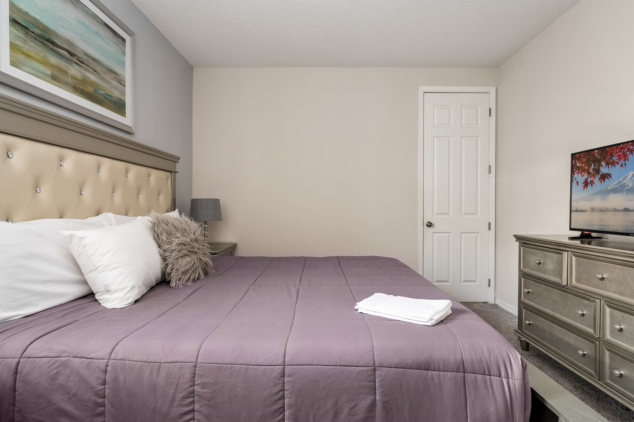 Quiet bedroom w/ neutral tones and a comfortable bed.