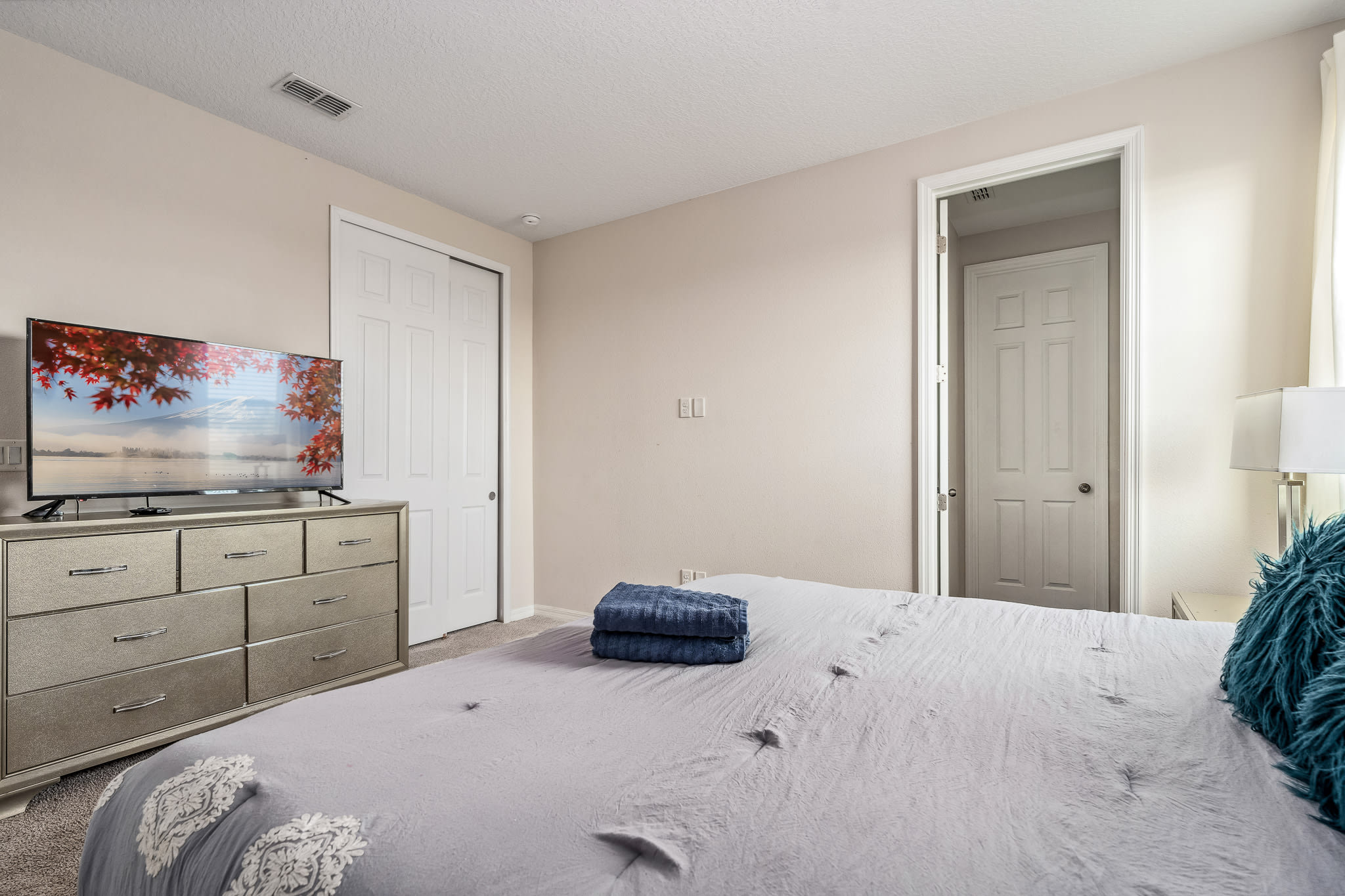 Bright bedroom w/ clean lines and a peaceful, uncluttered feel.