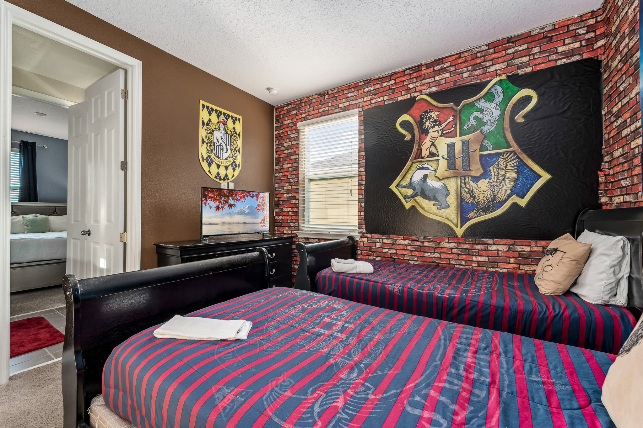 Themed bedroom w/ bold wall art and cozy bed for a fun stay.