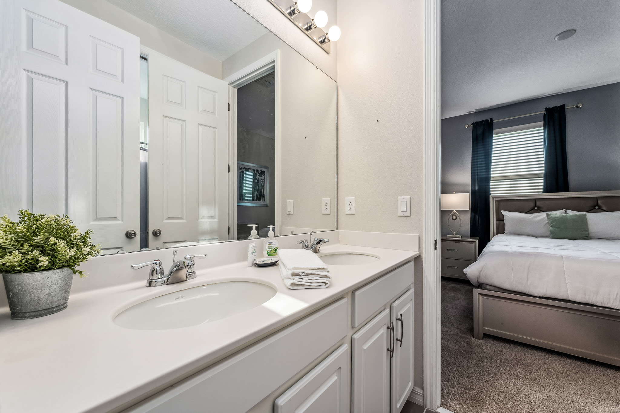 Clean-lined bathroom featuring a spacious vanity & fresh, modern details.