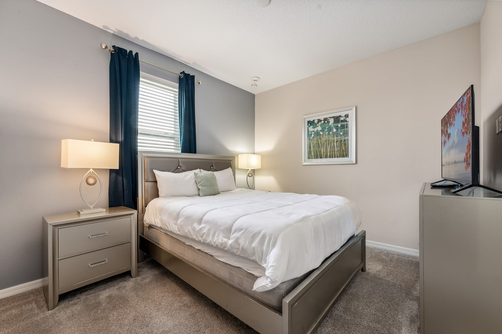 Calm bedroom retreat w/ a cozy bed, soft tones & simple, restful styling.