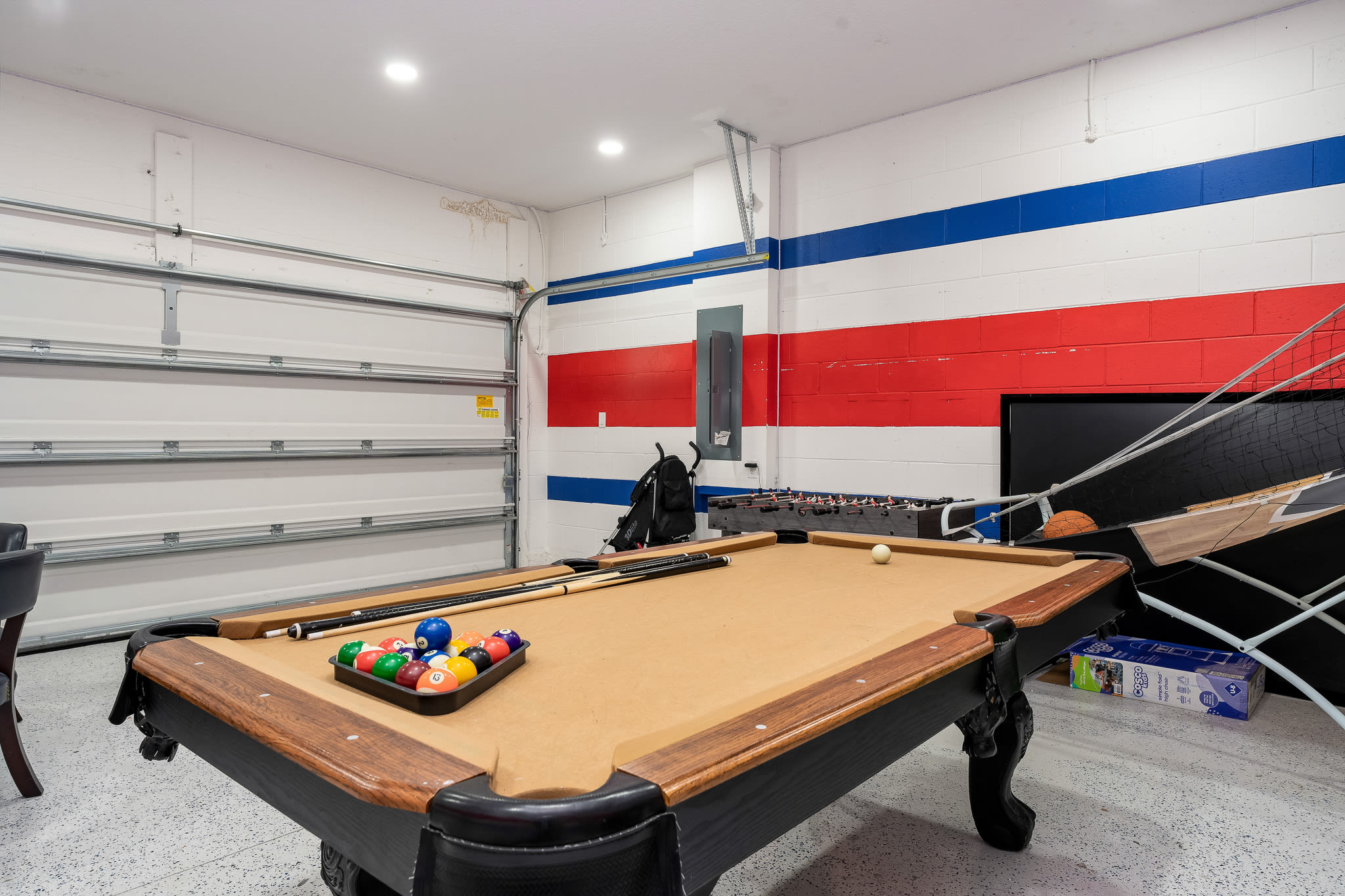 Game room w/ pool table and bold accents for friendly competition.