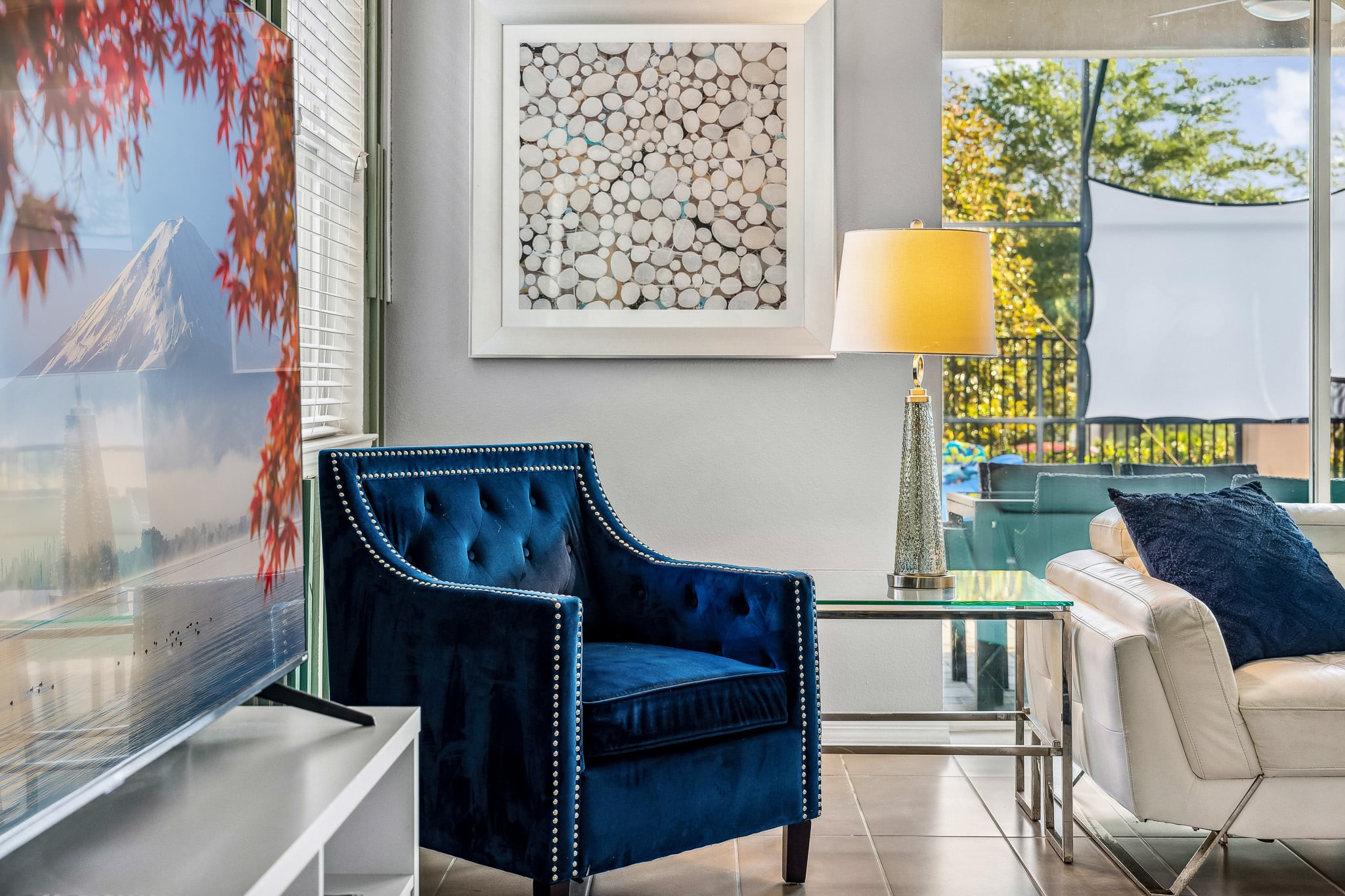 Stylish sitting nook w/ plush seating, warm accents & art that adds character
