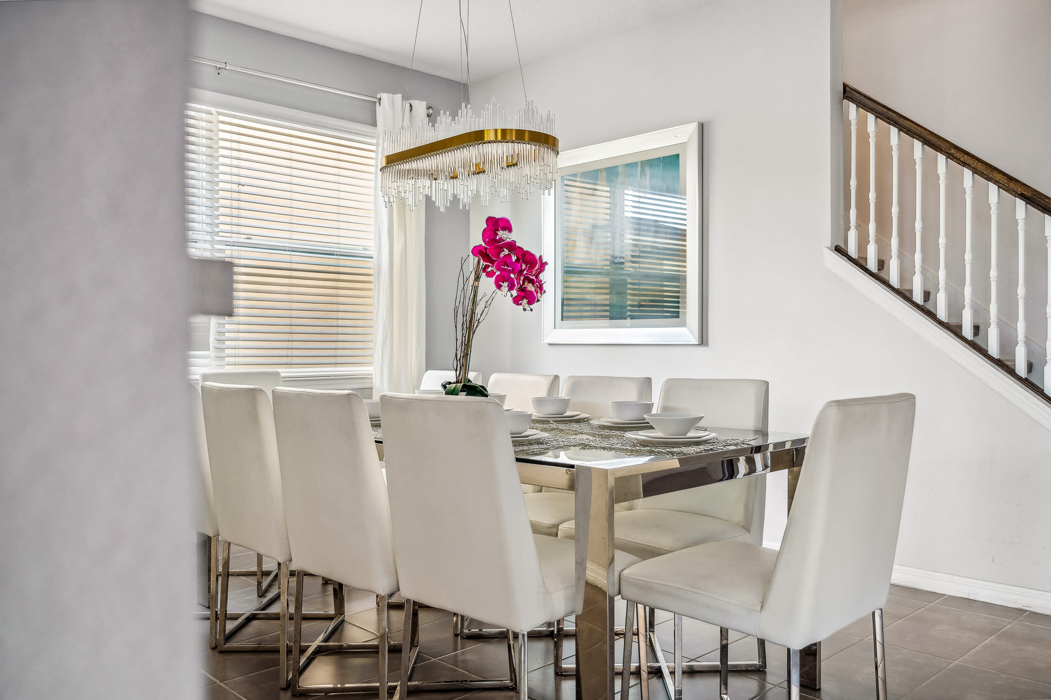 Bright dining area w/ a welcoming table, natural light & an open, airy vibe.