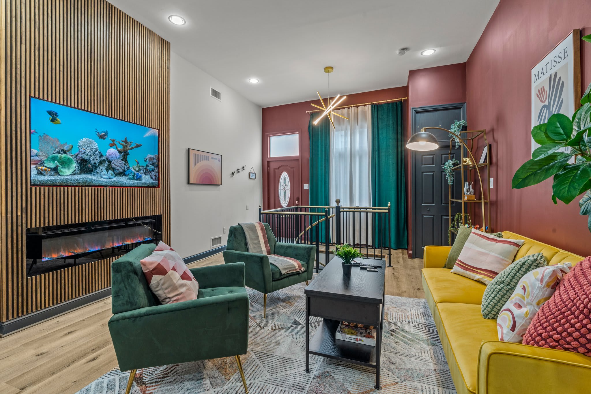 Step into elegance and comfort in this beautifully designed living room. You'll love relaxing on plush furniture while enjoying the warmth of the modern fireplace and the vibrant fish tank display on the Roku Smart TV. Every detail invites you to unwind.