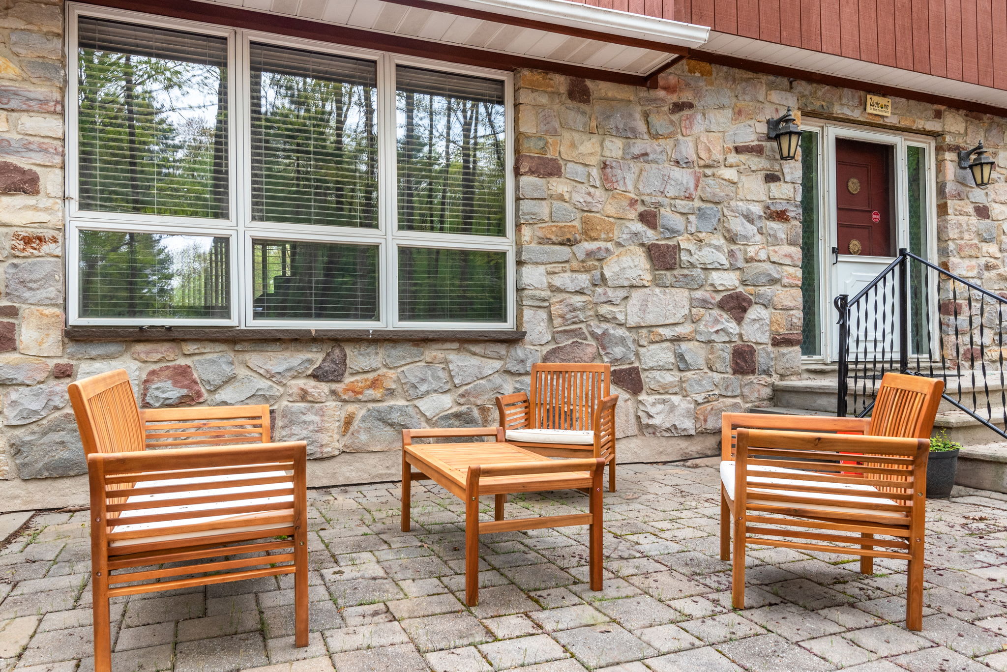 A stone-accented patio with comfortable seating, perfect for sipping your morning coffee or enjoying an evening conversation.