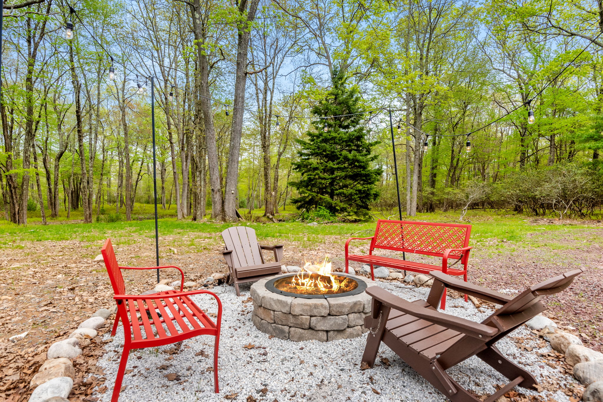 A welcoming firepit area surrounded by Adirondack chairs, ideal for roasting marshmallows and sharing stories under the stars.