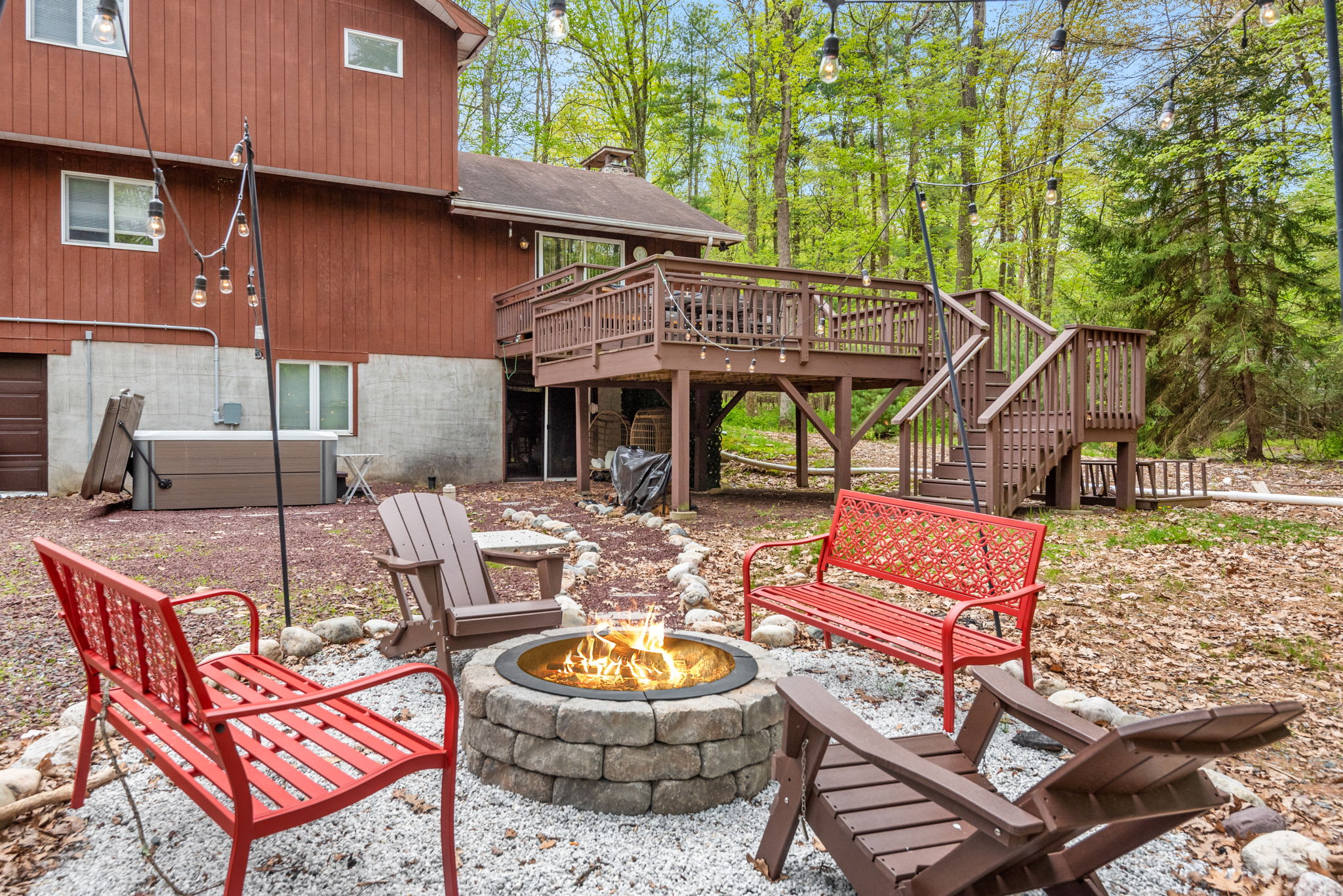 A cozy firepit area with Adirondack chairs, perfect for gathering with friends and family to enjoy the crackling flames.