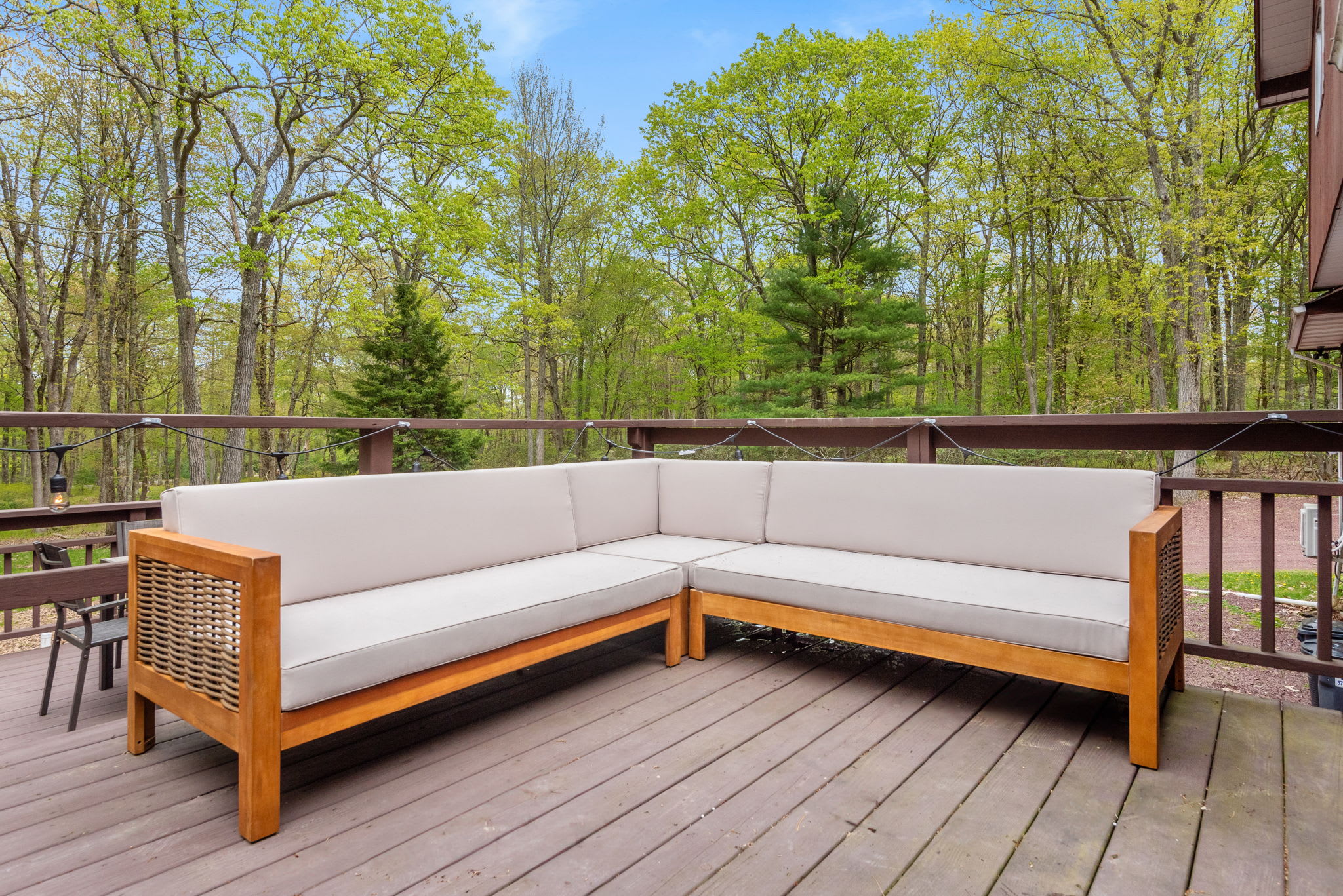 A beautifully designed deck with plush outdoor seating, offering a peaceful spot to enjoy your morning coffee or evening drinks.