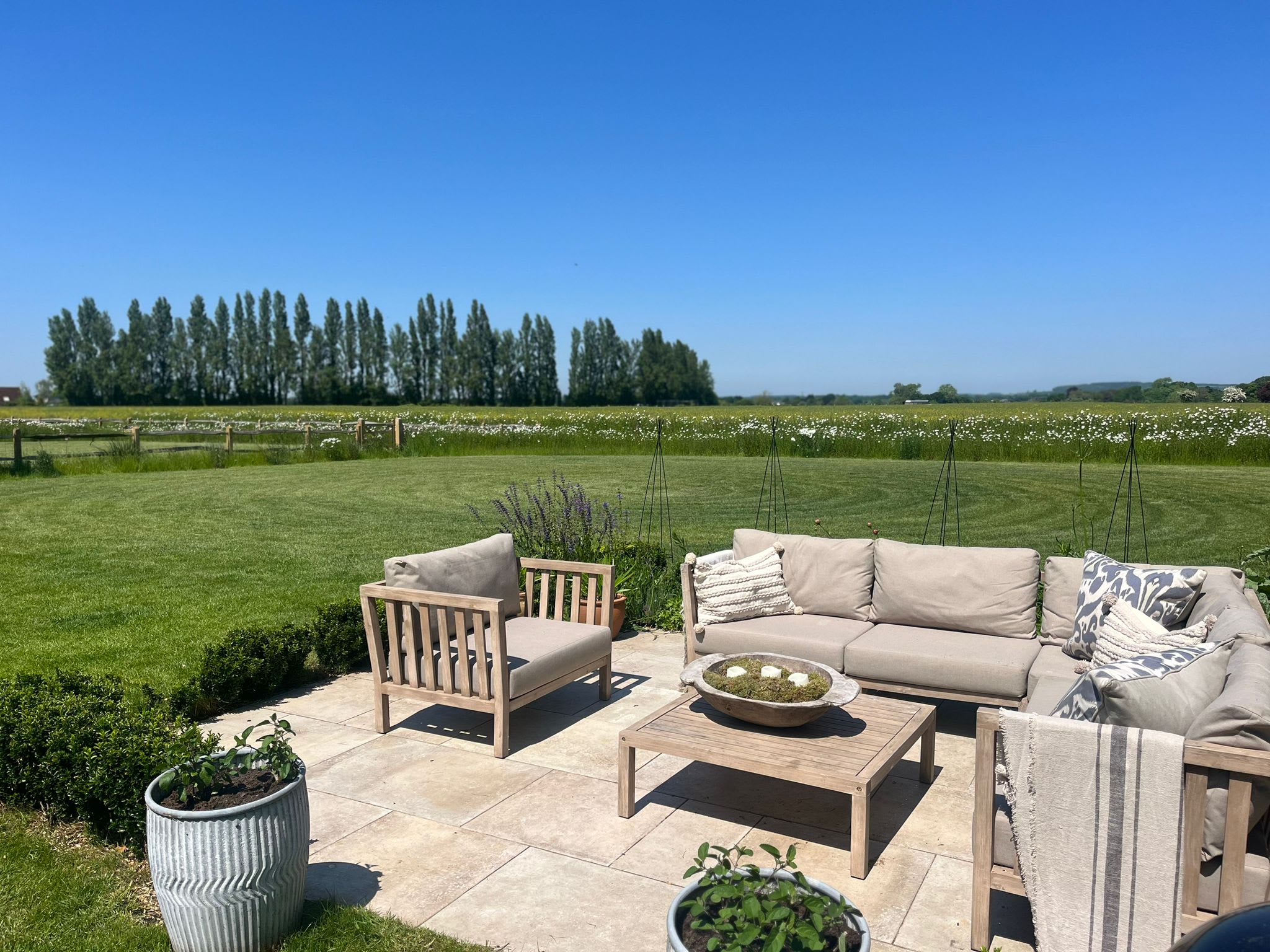 The outdoor seating area looks out over fields, deer frequently walk across te field in the mornings