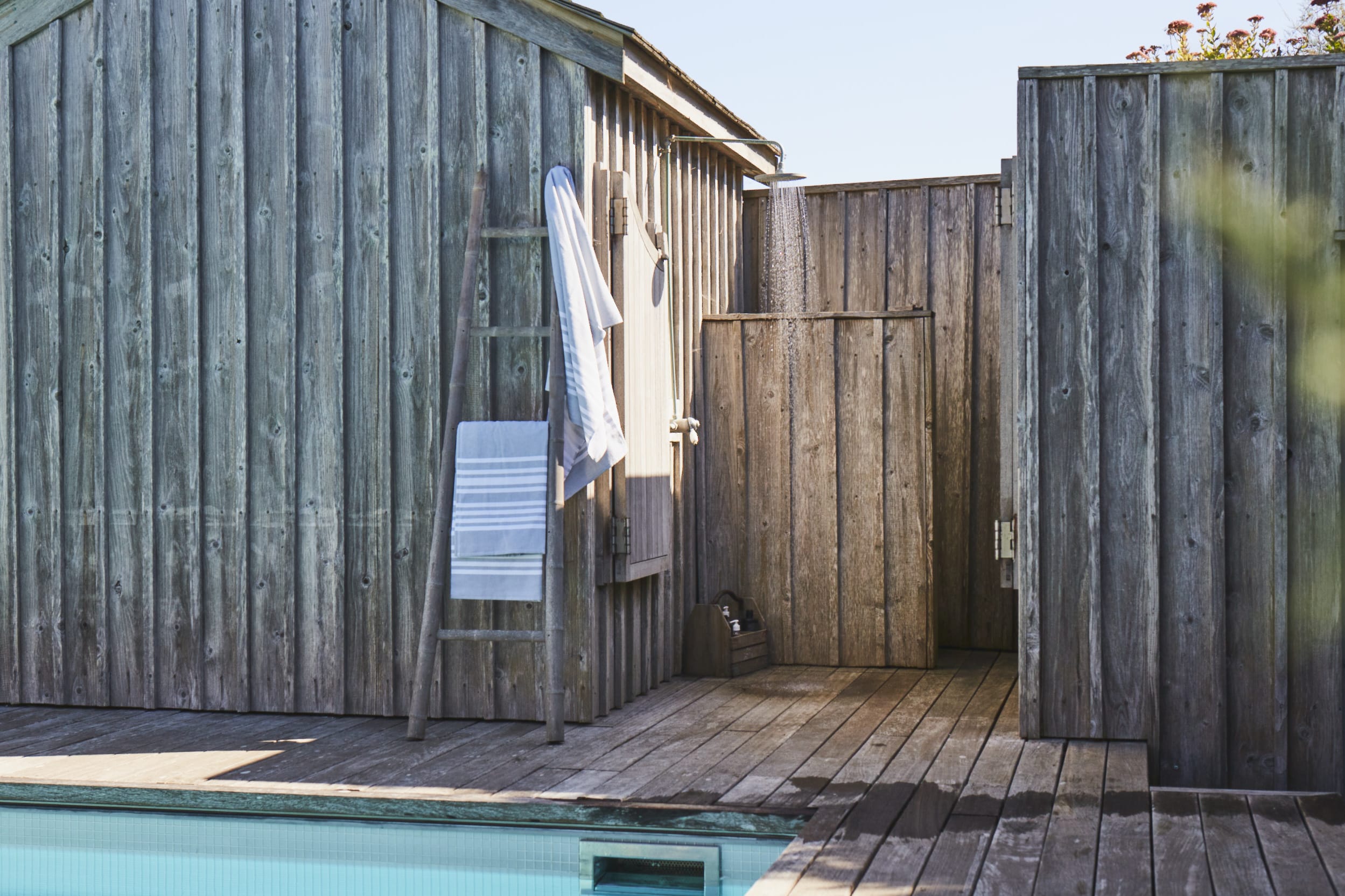 Outdoor shower by the pool, perfect for rinsing off after a swim or a day at the beach