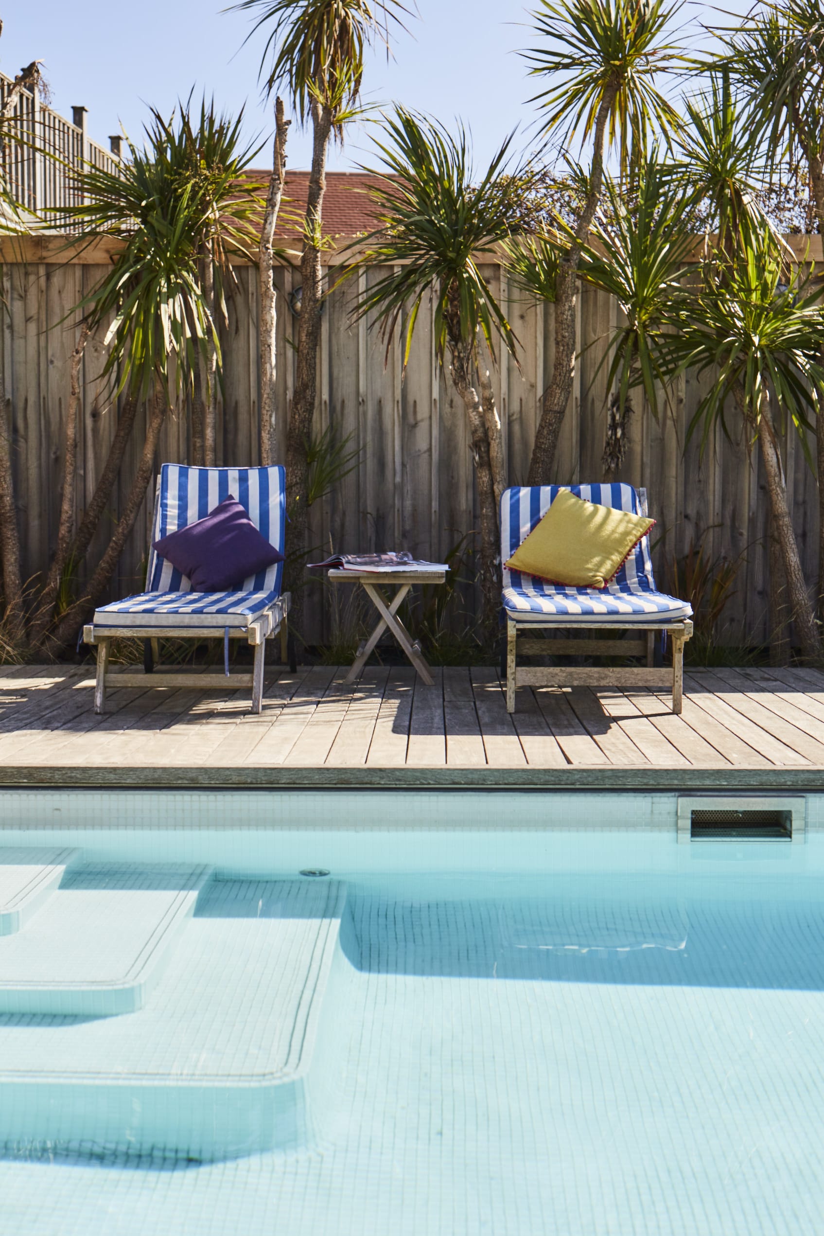 Enjoy a refreshing dip in our private swimming pool, surrounded by lush greenery