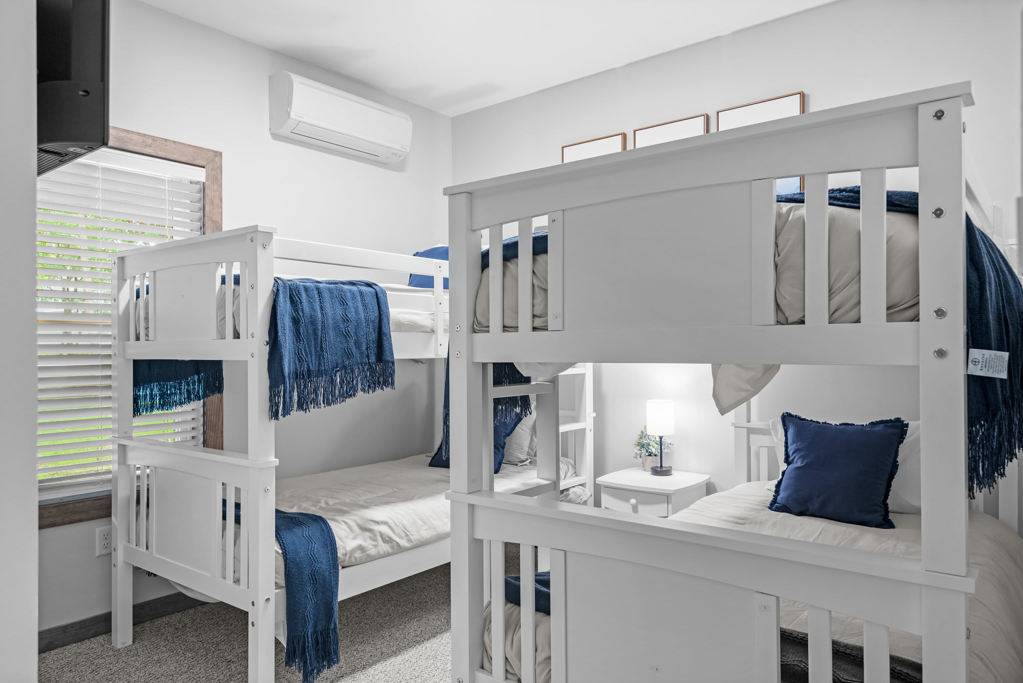 A cozy bunk setup with clean lines and soft lighting, perfect for kids or groups, with plenty of space and charm.