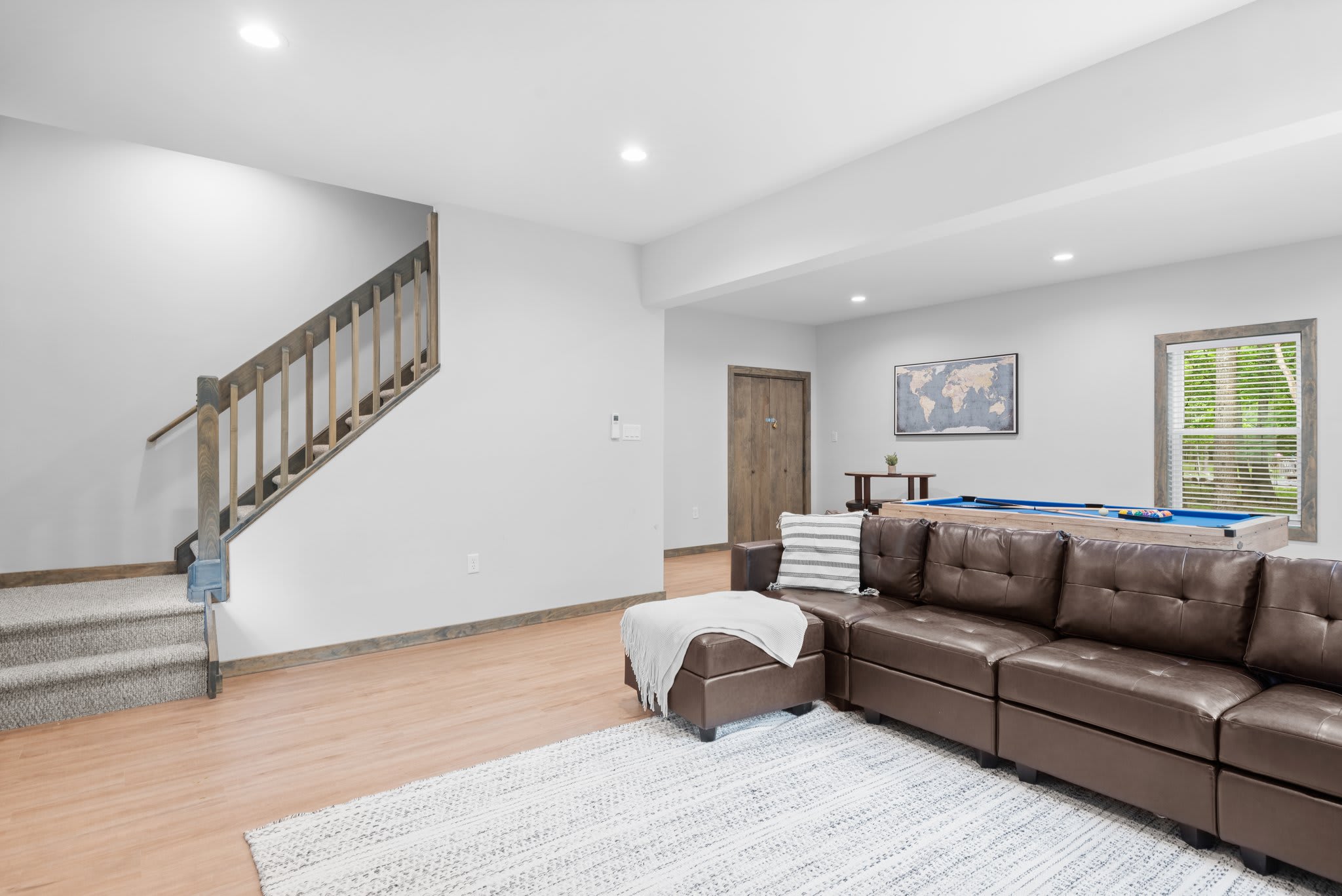 A spacious hangout zone that ties everything together, with plenty of seating and room to relax, chat, or catch a game.