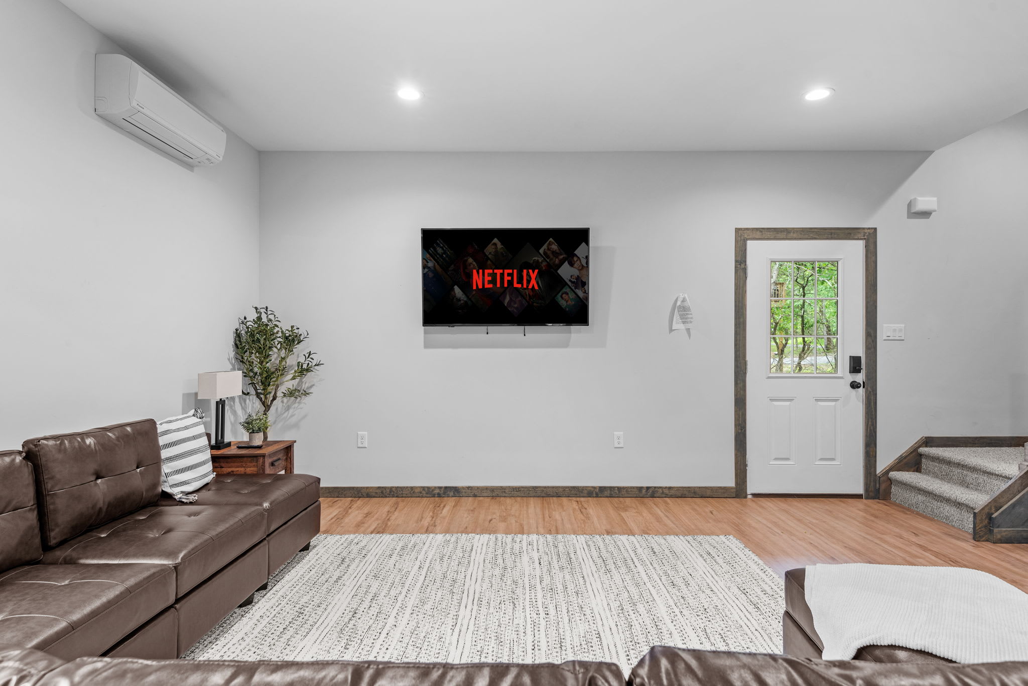 This warm and welcoming space flows effortlessly from the front door to the living area, where comfort meets clean design.