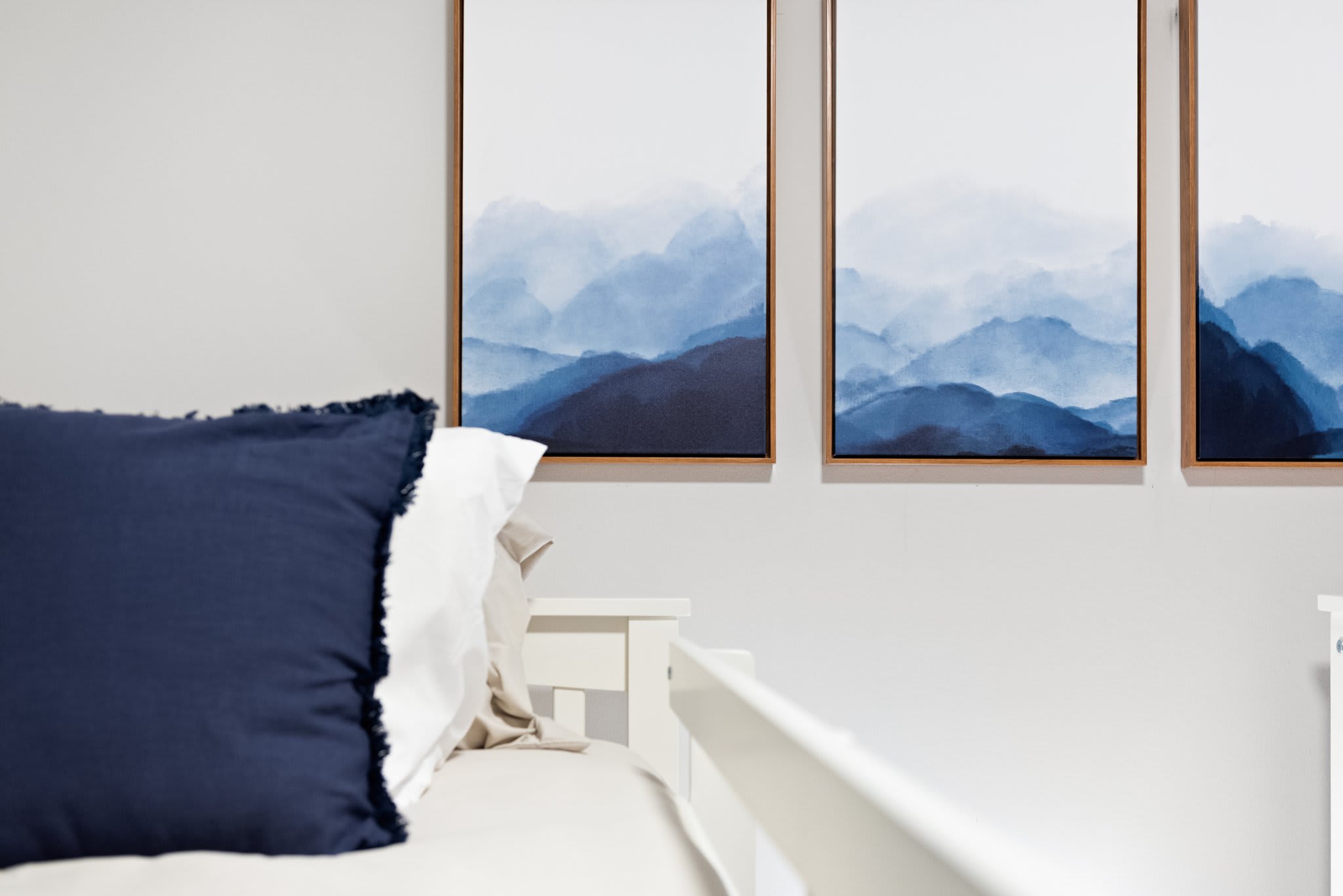 Soft textures and calming tones make this space feel like a little retreat. The mountain artwork adds a peaceful, modern touch.