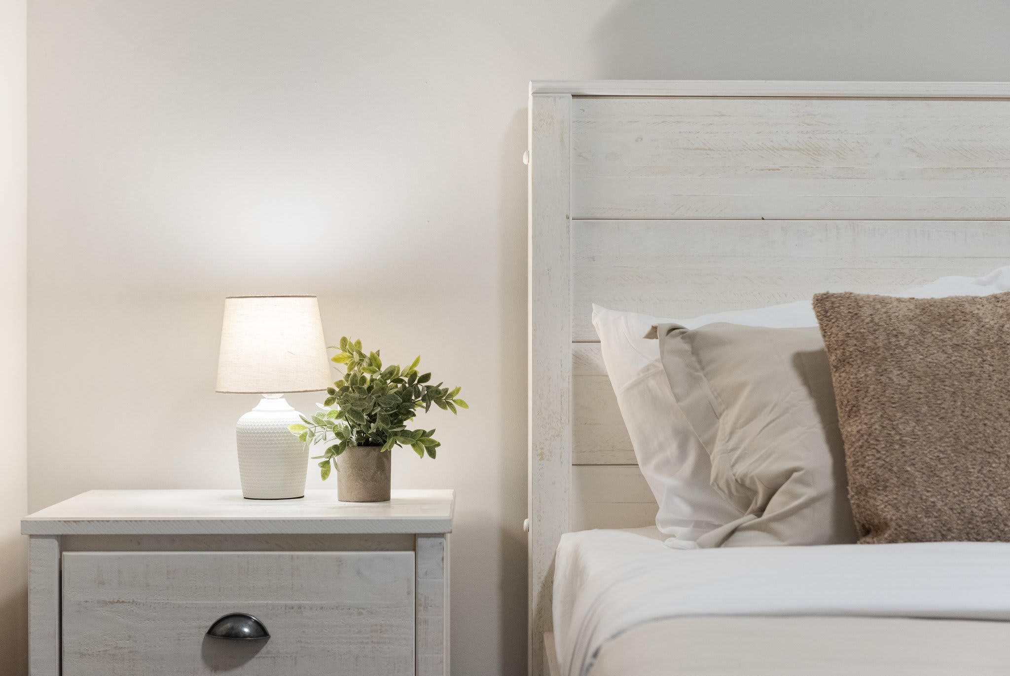 Soft whites and neutrals keep this room light and airy, with just the right amount of cozy charm for a quiet evening in.