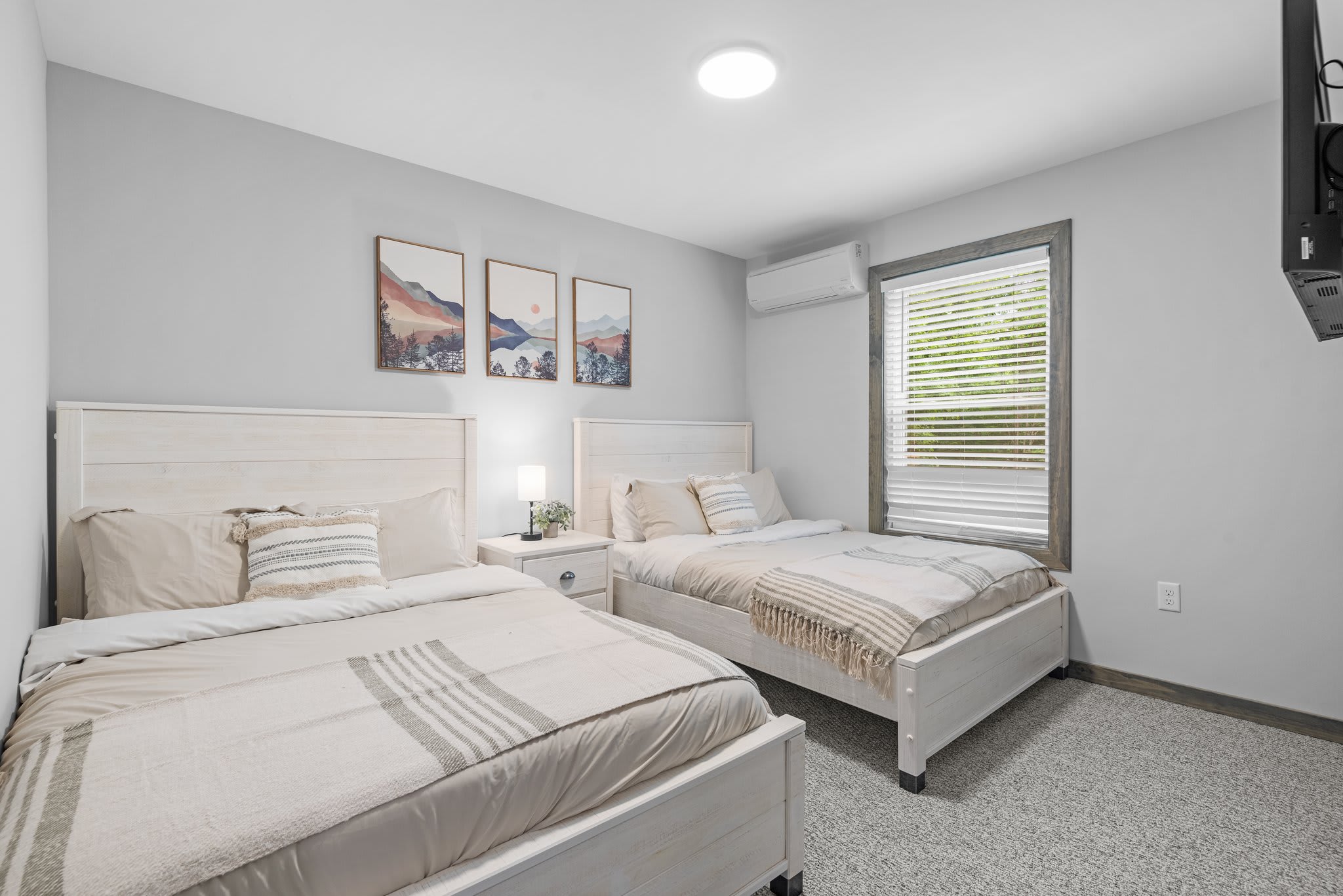 A bright and airy room that’s perfect for kids or friends. The soft tones and simple decor make it both restful and functional.