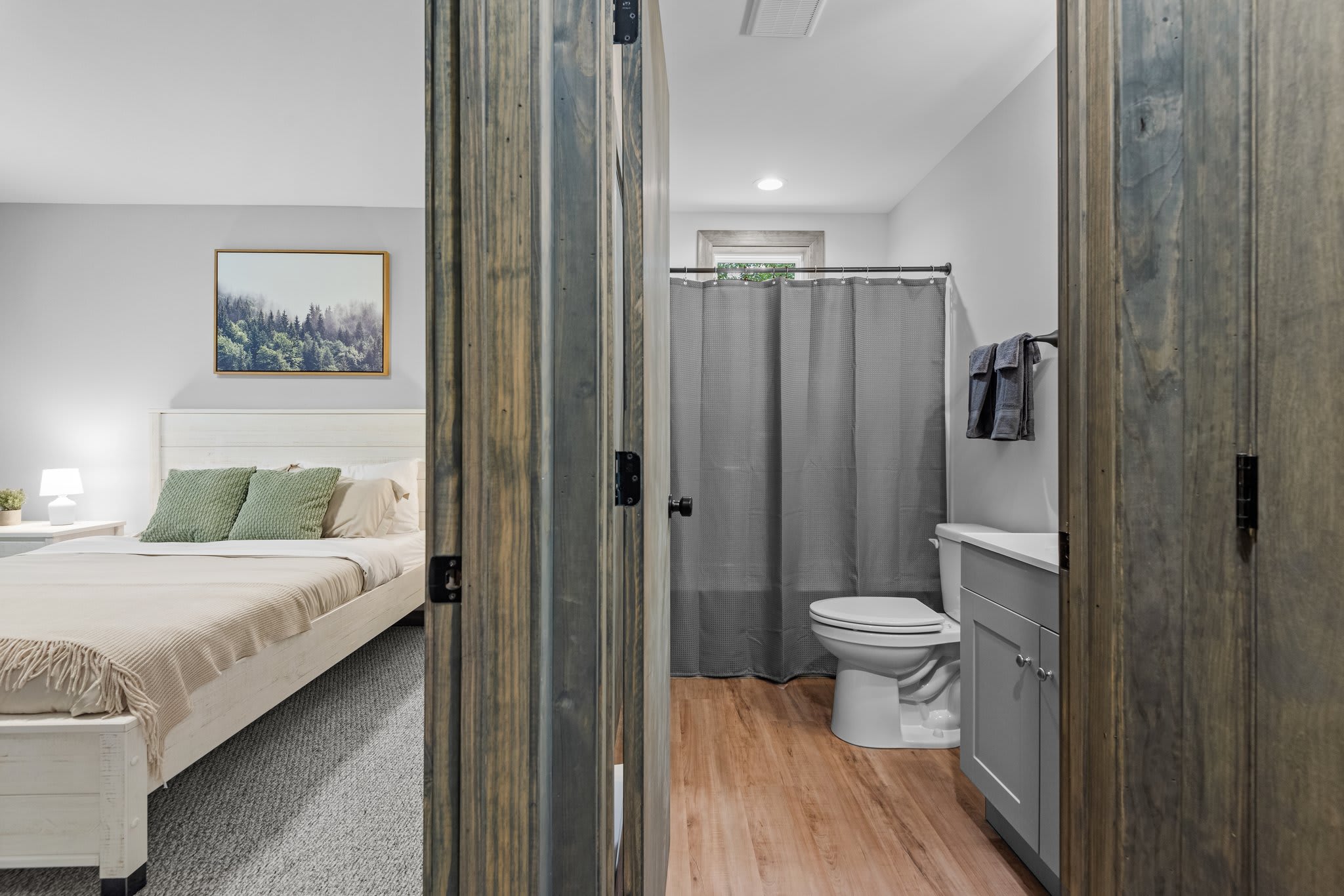 This layout connects the bedroom and bath with ease. The rustic doors add charm while keeping things private and functional.