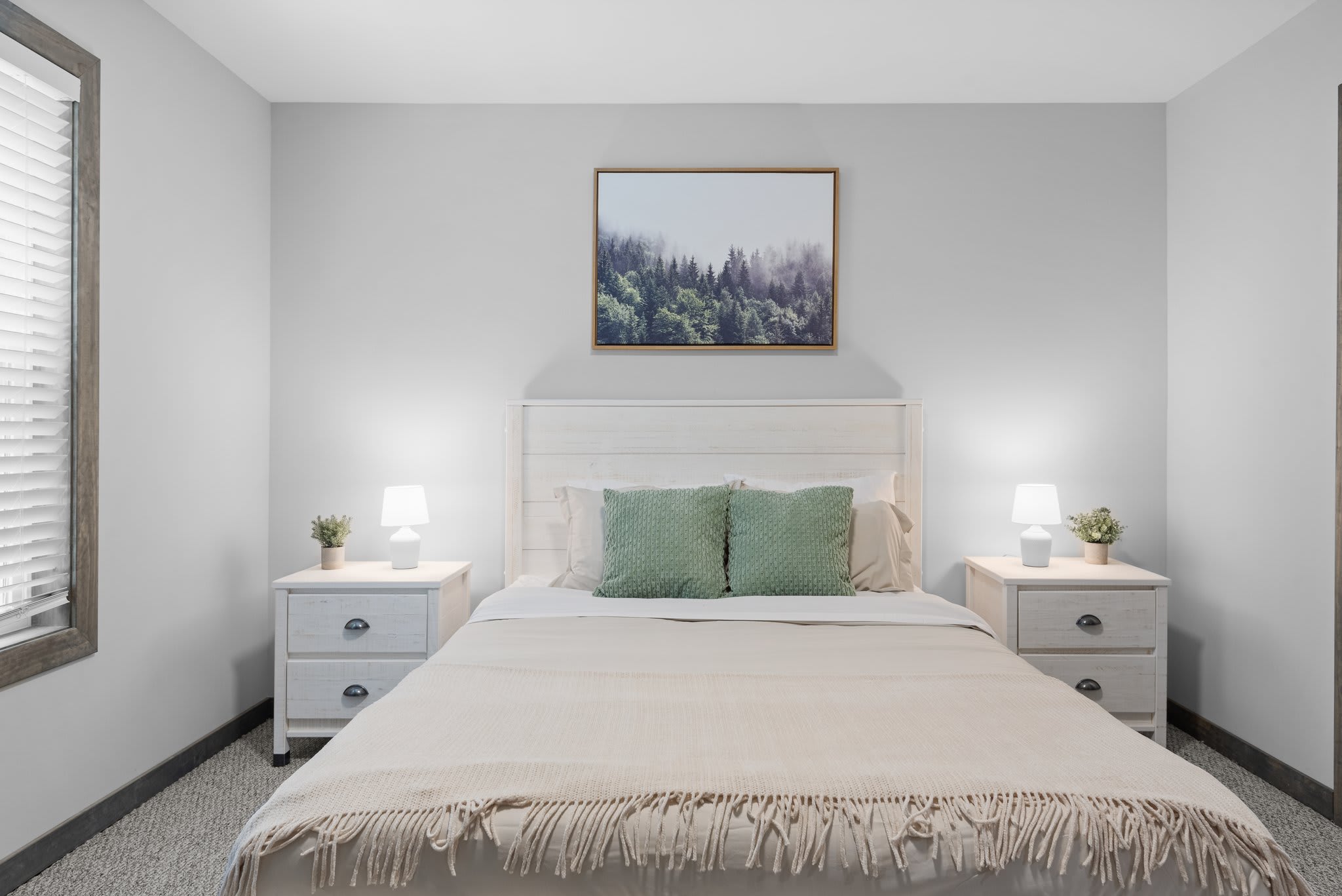 A queen-size bed with soft lighting and calming colors. Paired with clean lines and thoughtful details, this room is a peaceful escape.