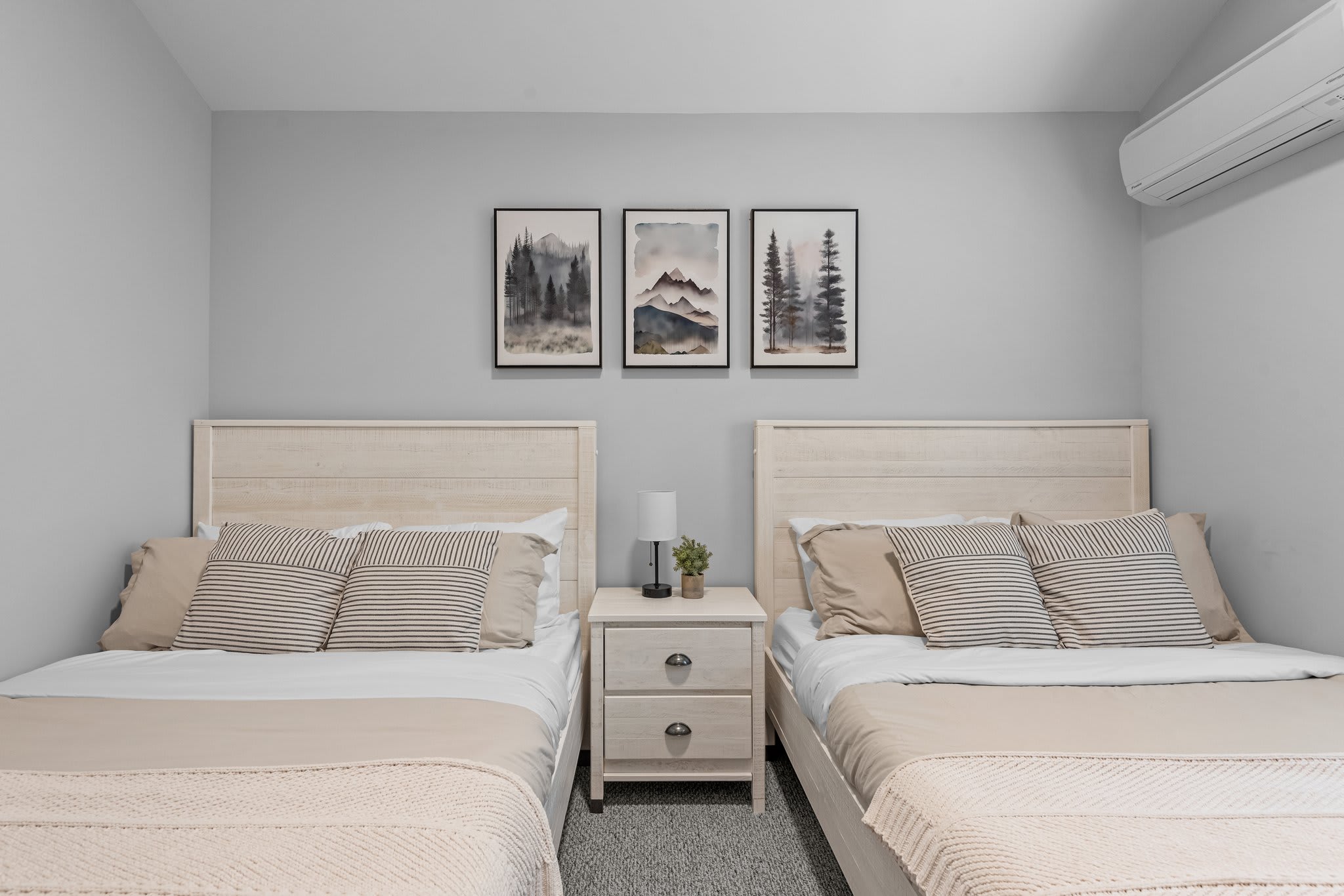 2 double beds with matching decor and soft lighting make this room a peaceful place to wind down after a long day.