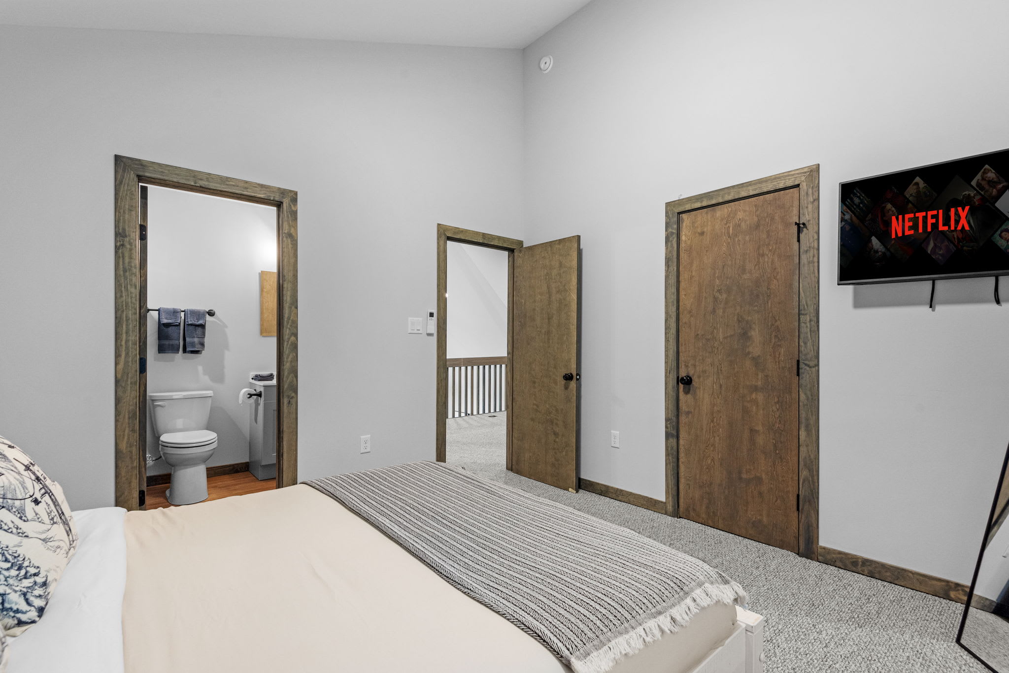 TV and Hallway View 
This angle shows off the mounted TV and easy flow into the hall and bathroom. Great for staying entertained and comfortable.