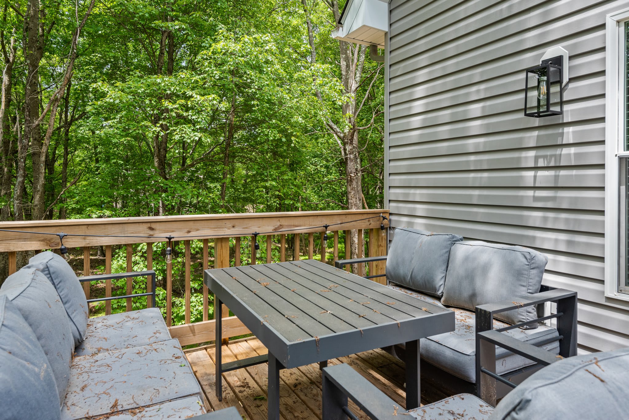 Side Deck Seating Area
This cozy nook on the side deck is made for morning coffee or evening chats, tucked up against the woods for a relaxing vibe.