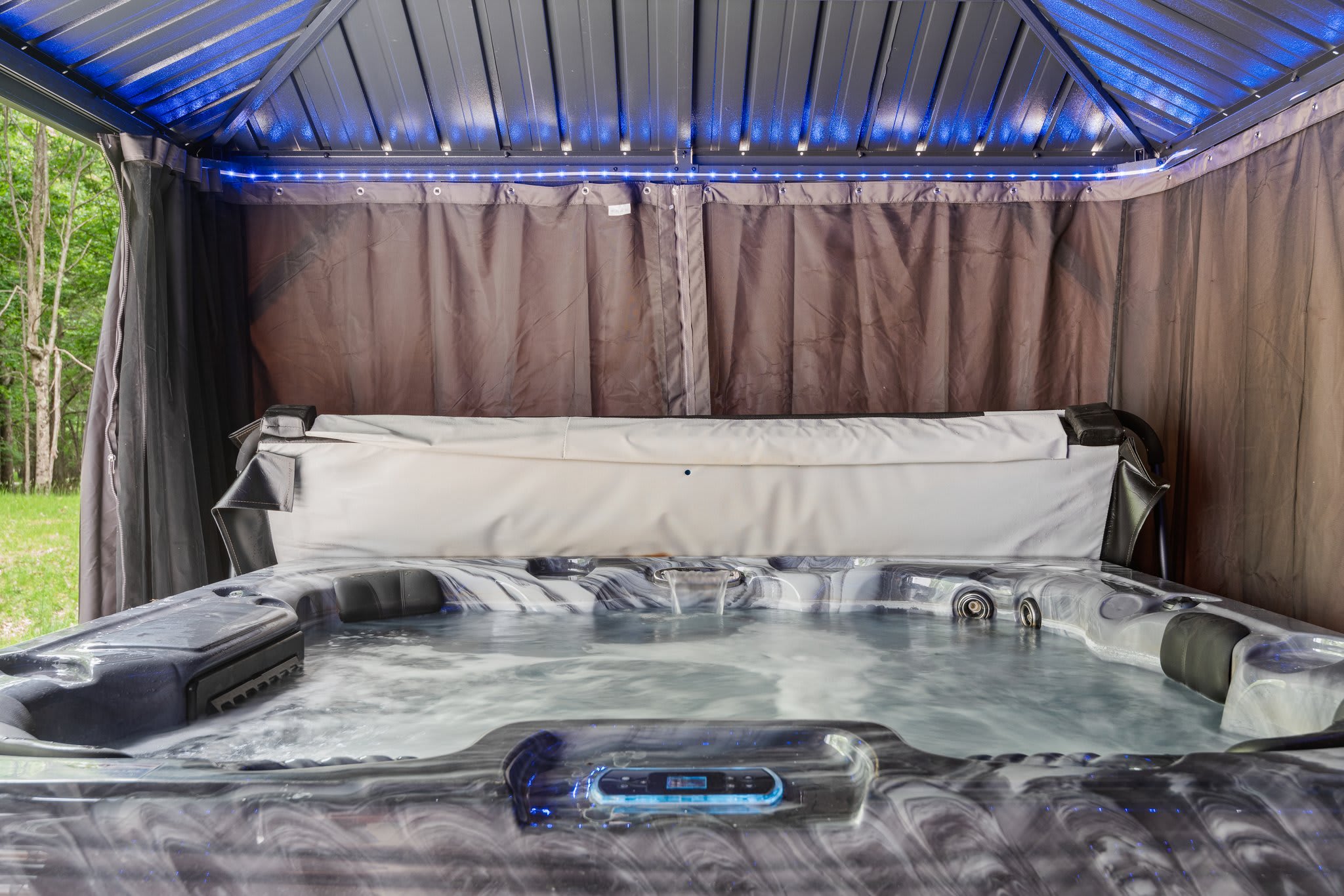 The ultimate chill zone. Soft lighting and privacy curtains wrap around a bubbling spa that’s ready to ease you into vacation mode.