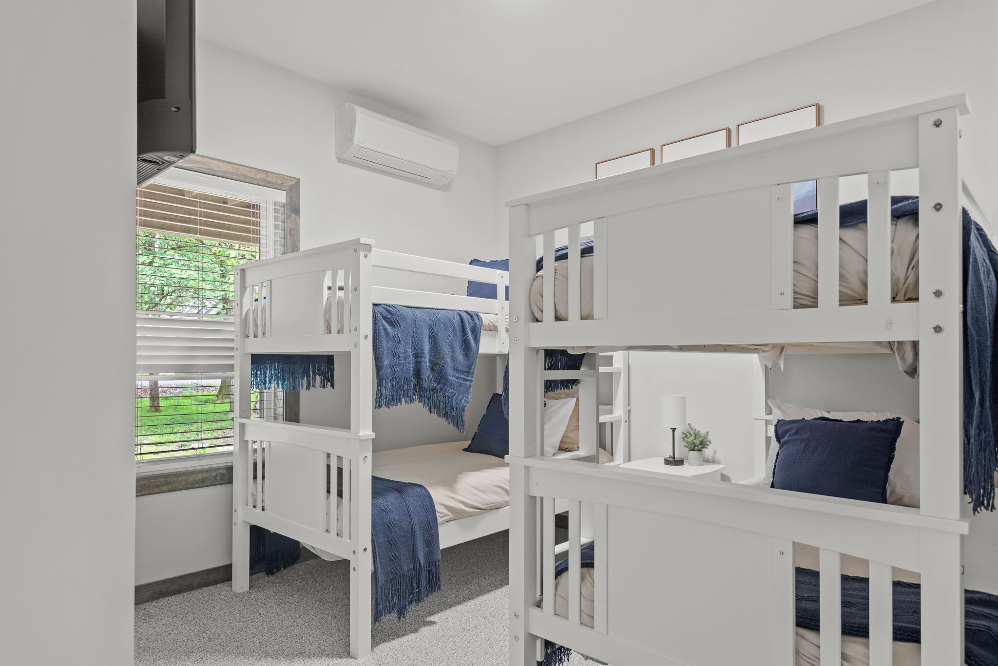 Bright, functional, and fun. This space has two sets of bunk beds and a mounted TV for movie nights or chill-out time.