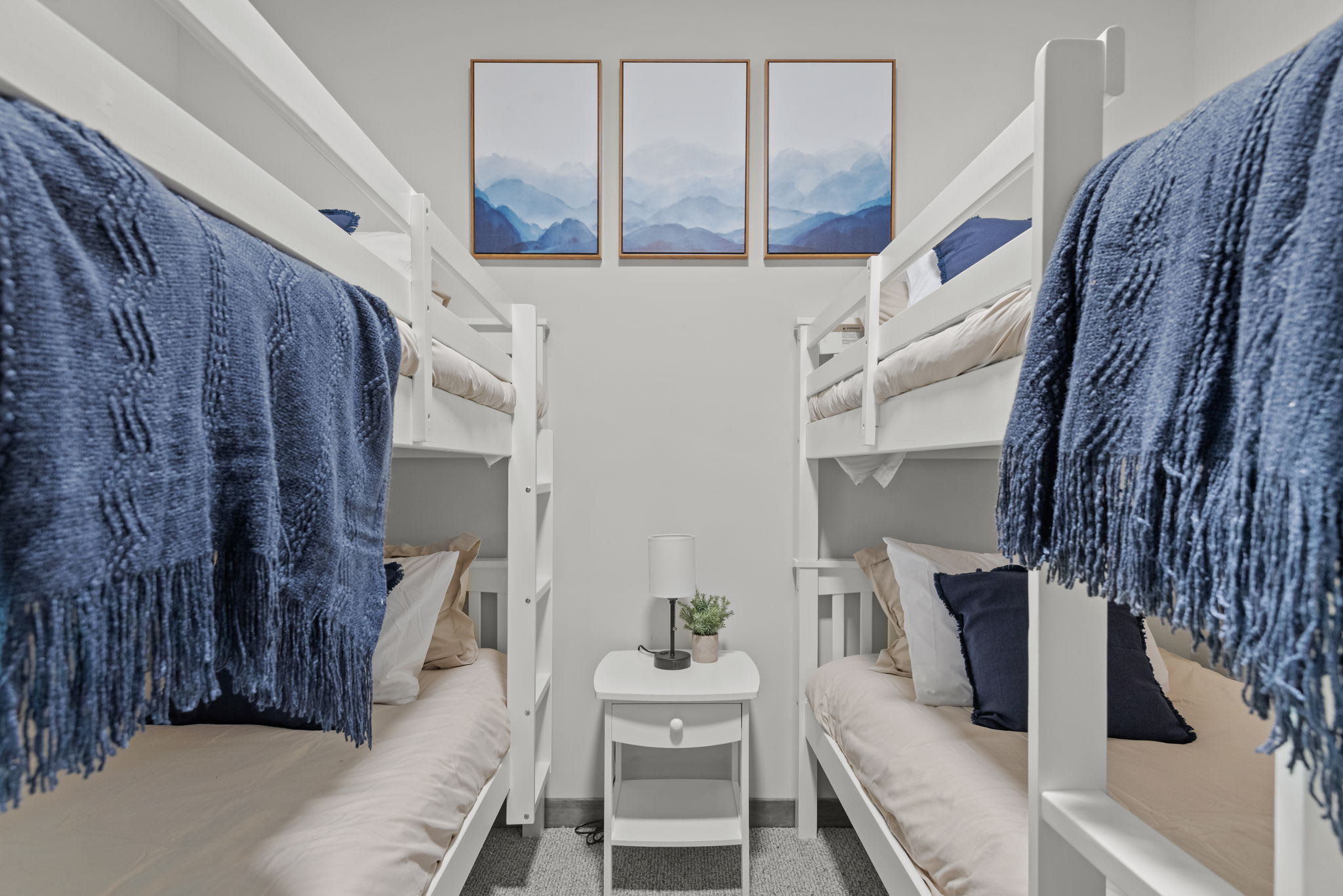 Clean lines and cozy bedding make this a picture-perfect sleep setup for kids or groups.