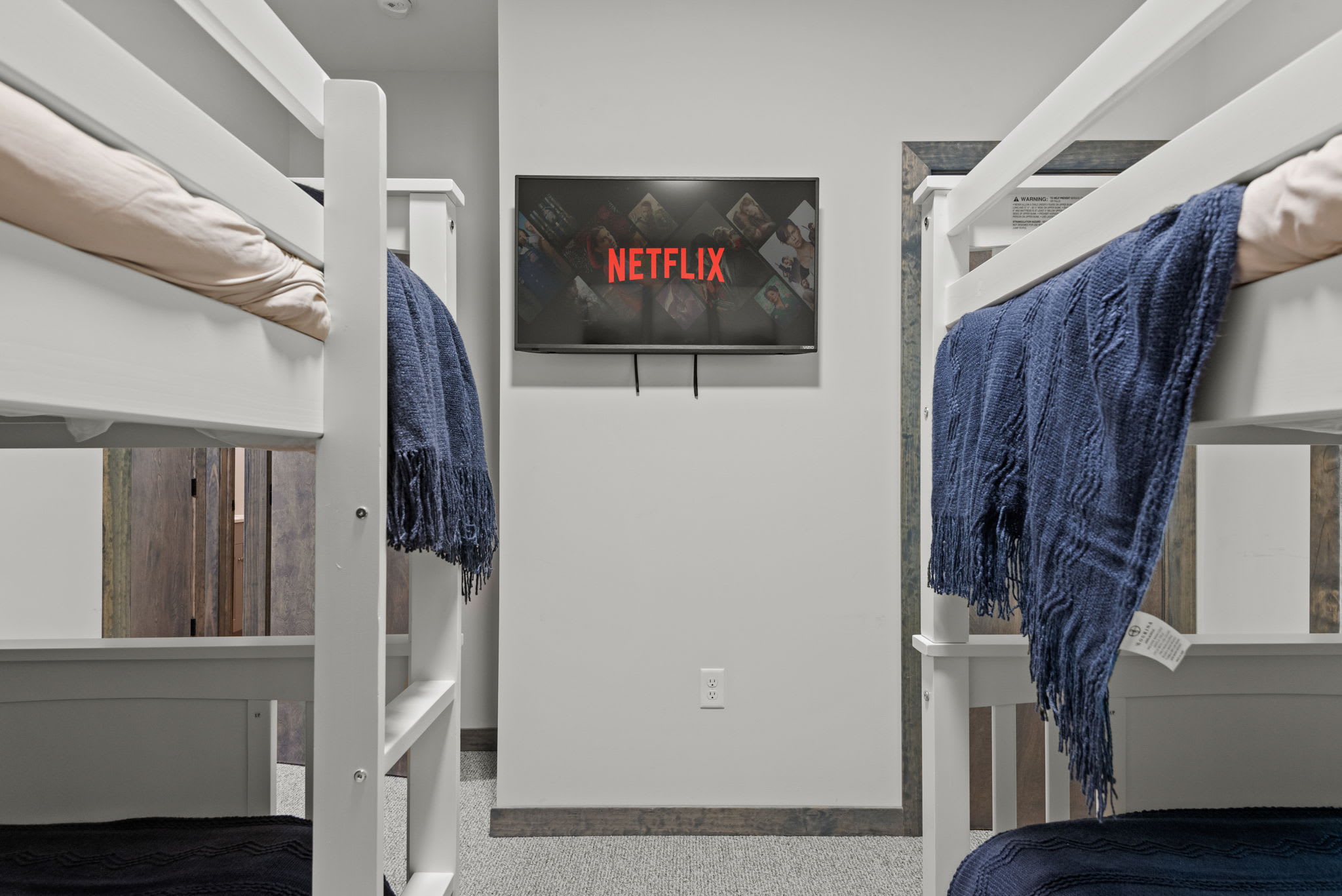 Tucked in between the bunks, the wall-mounted TV adds a cool, private cinema feel to the space.