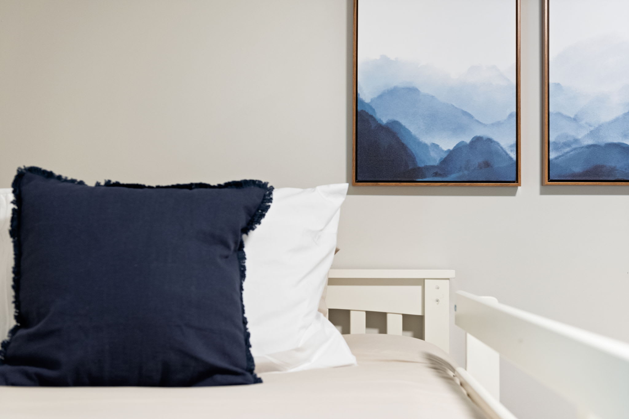 A closer look at the textures and wall art that add a warm, calming feel to the bunk room.