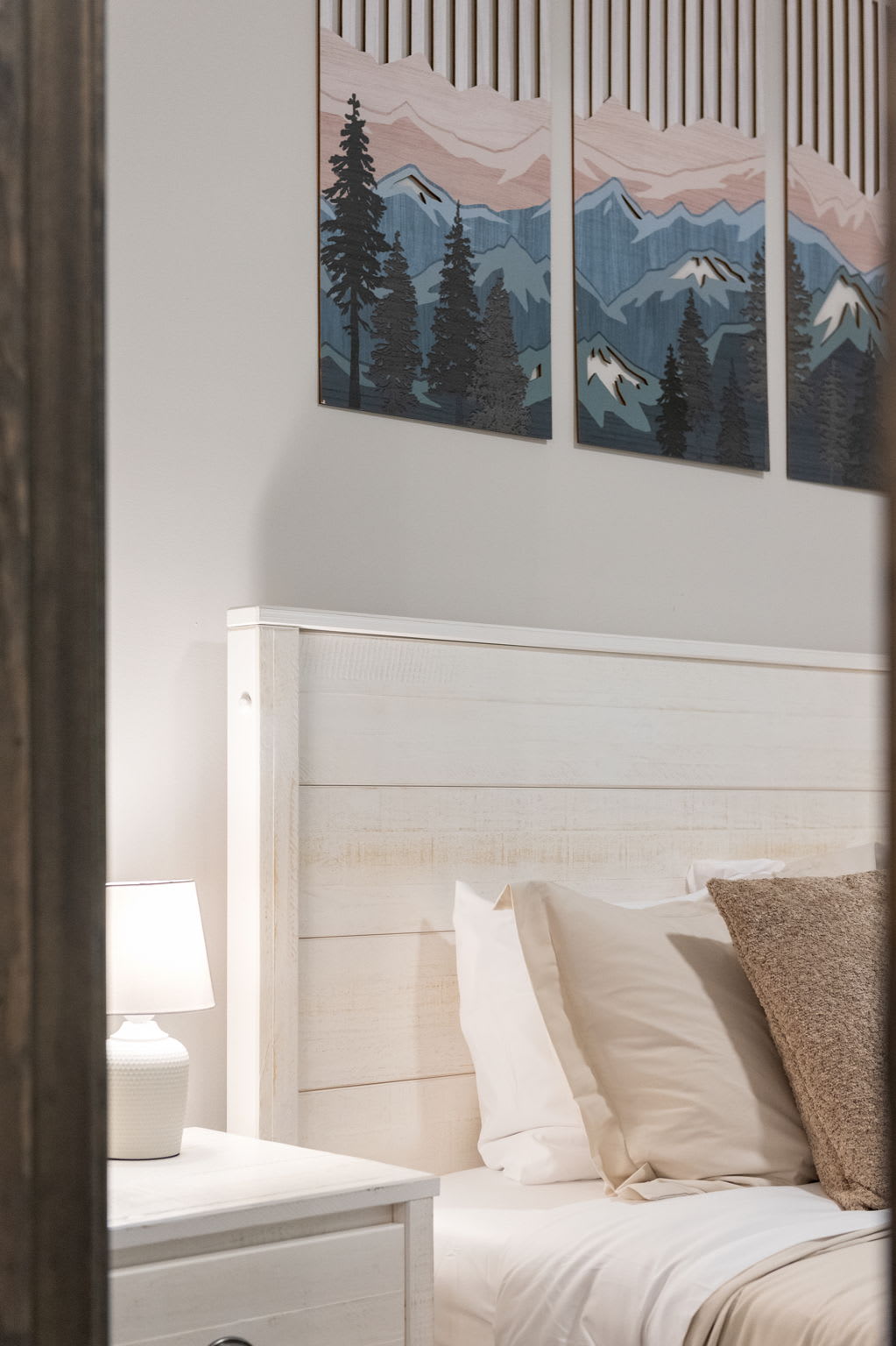 This view shows off the cozy layout and matching bedside tables, all styled in neutral tones for a peaceful vibe.