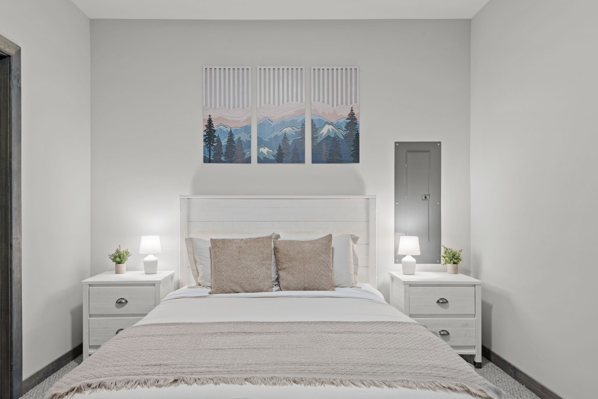 Clean and balanced with soft lighting and a peaceful mountain art piece that sets a relaxing tone.