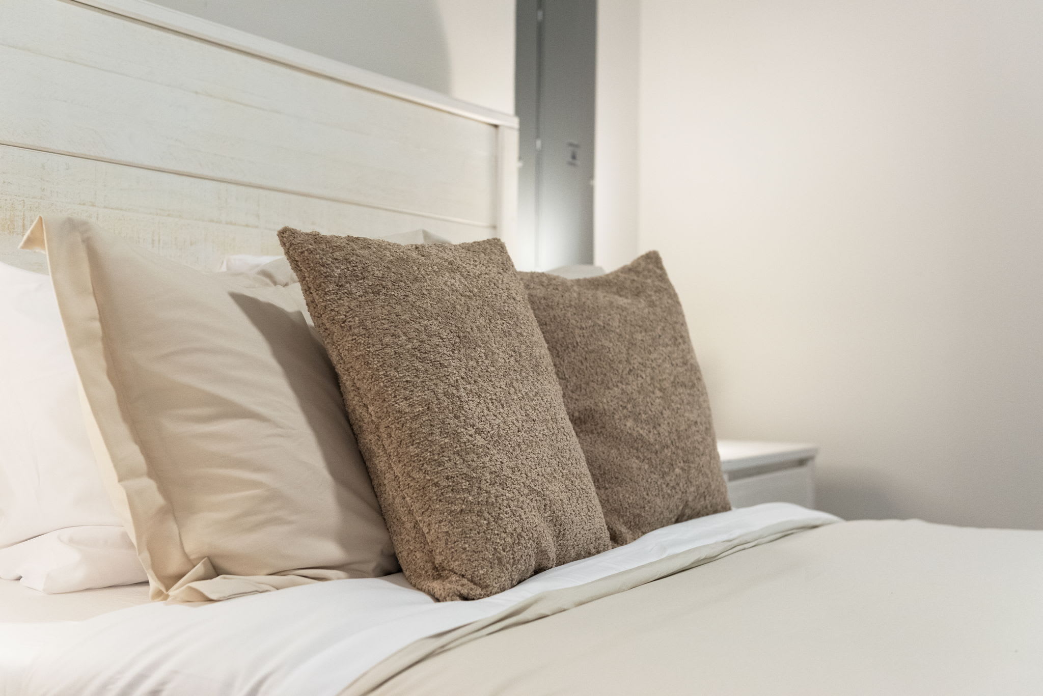Simple textures and soft neutrals make this bed feel extra inviting after a long day.