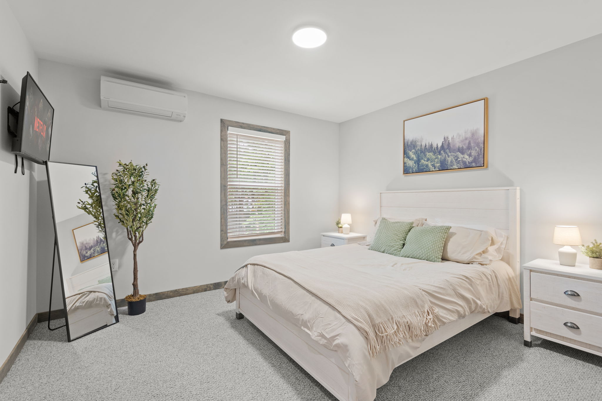 Spacious and softly styled with a mounted TV and full-length mirror. A perfect mix of function and calm.