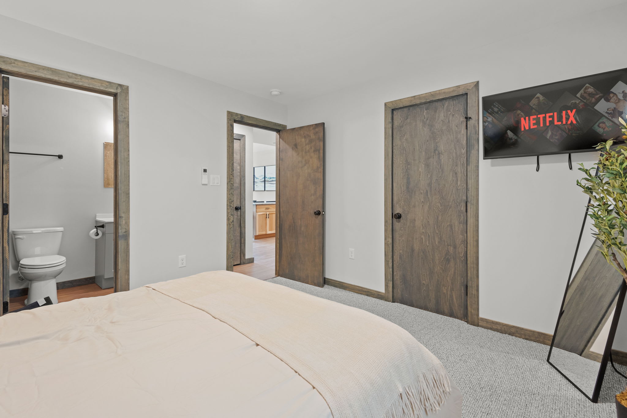 Side View
This angle highlights the spacious layout, mounted TV, and bathroom access that make this room both cozy and convenient.