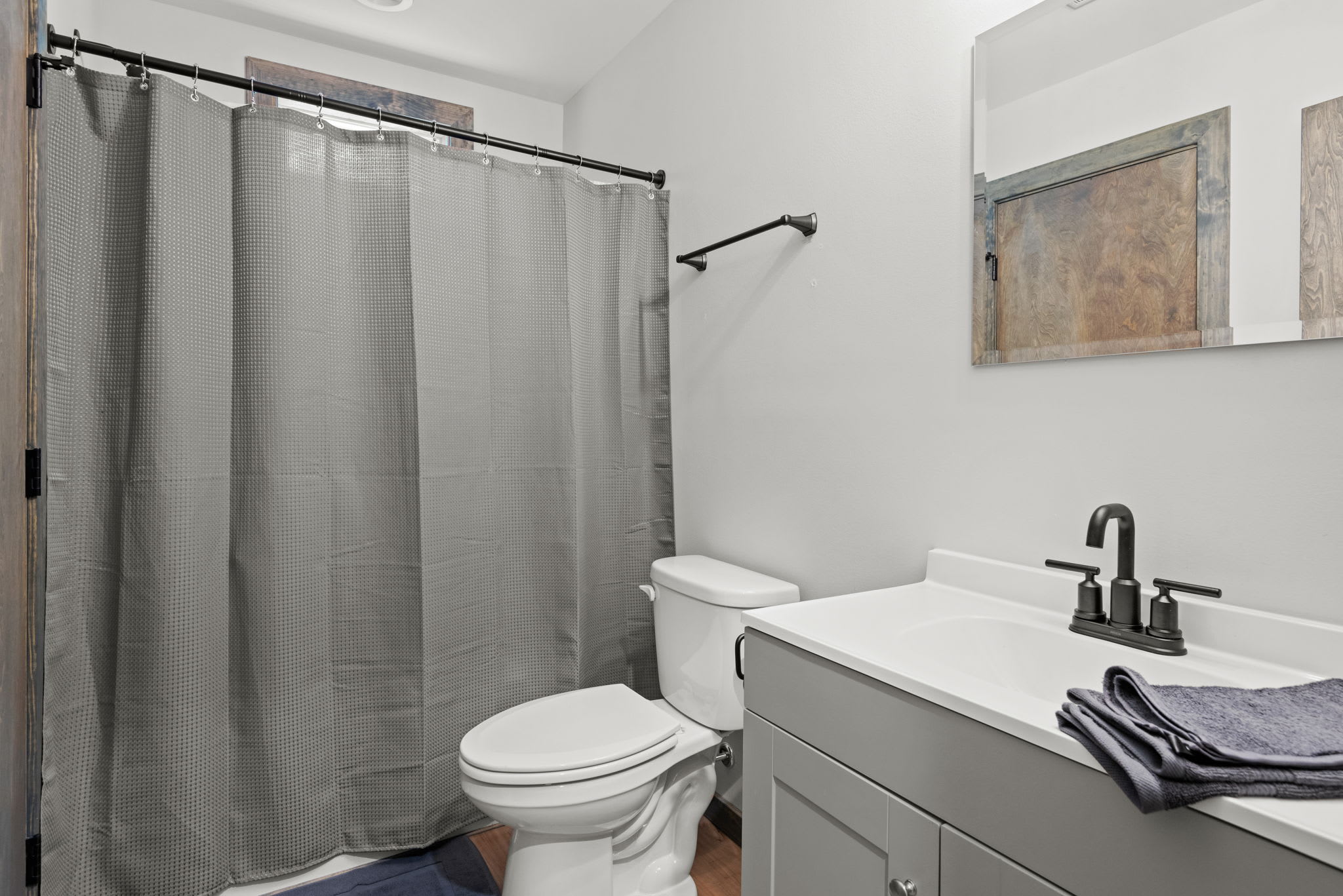 This full bath offers a clean design with modern black hardware and plenty of counter space to keep things practical.